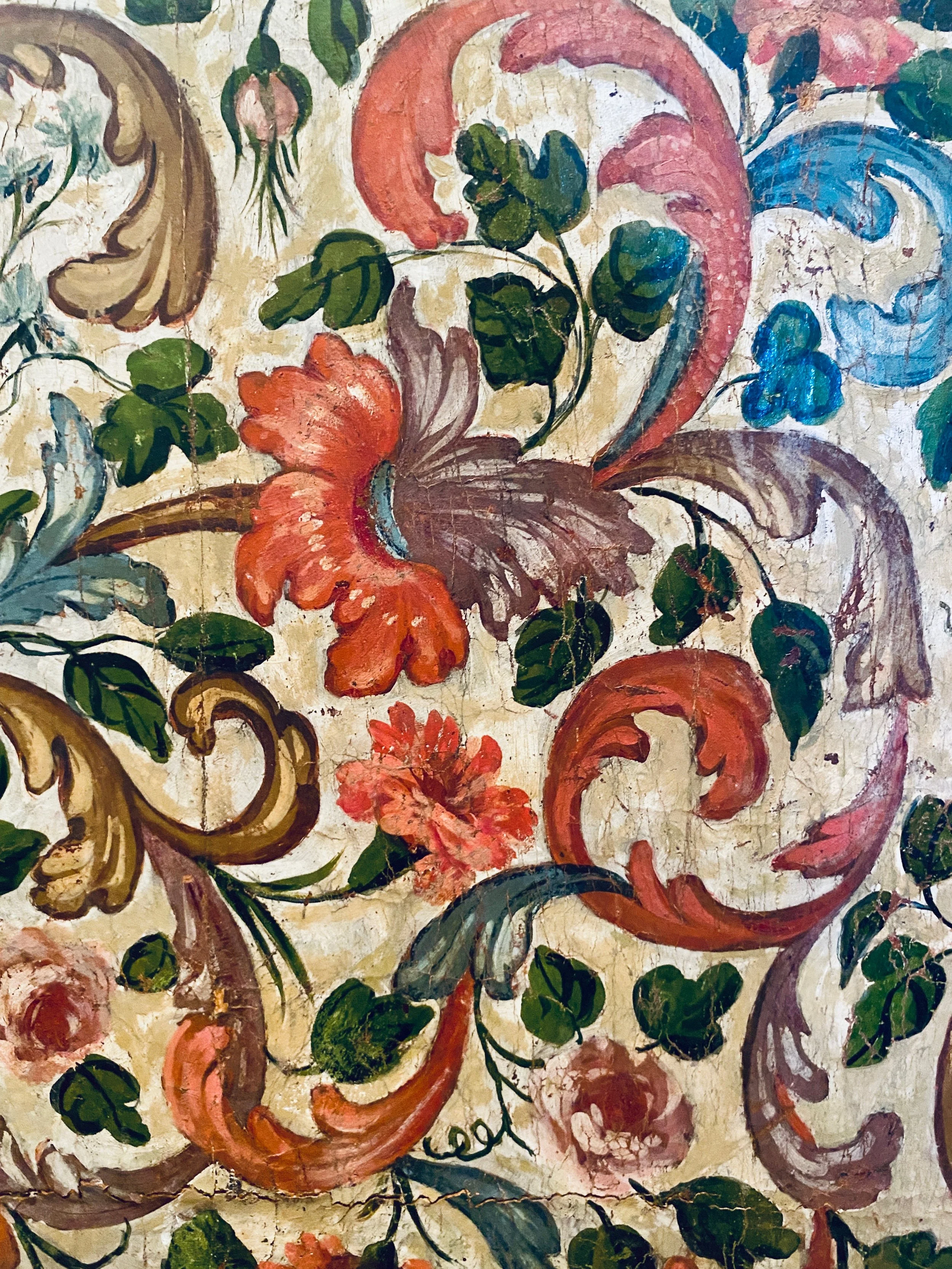 A detailed, colorful floral painting with large orange and pink flowers, green leaves, and swirling brown and beige patterns, creating an ornate, vintage look.