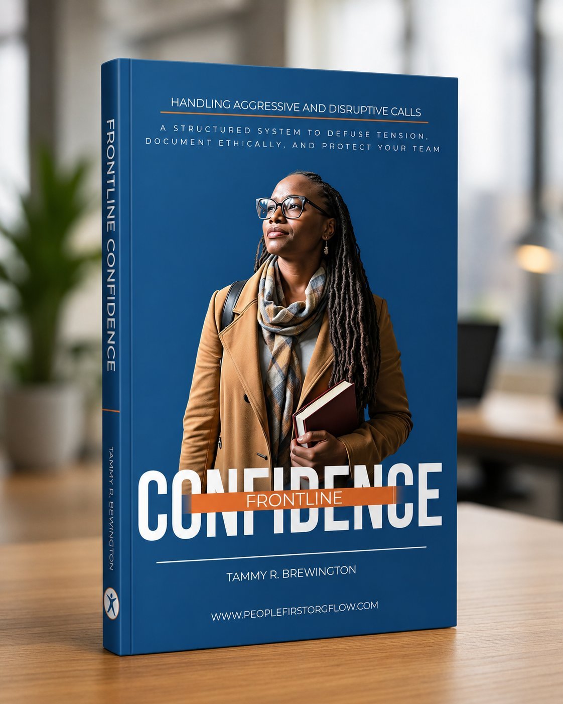 Book titled 'Confidence Frontline' by Tammy R. Brewington, featuring a woman with glasses, dreadlocks, a camel coat, a scarf, and holding a book, standing in a modern indoor setting with blurred background.