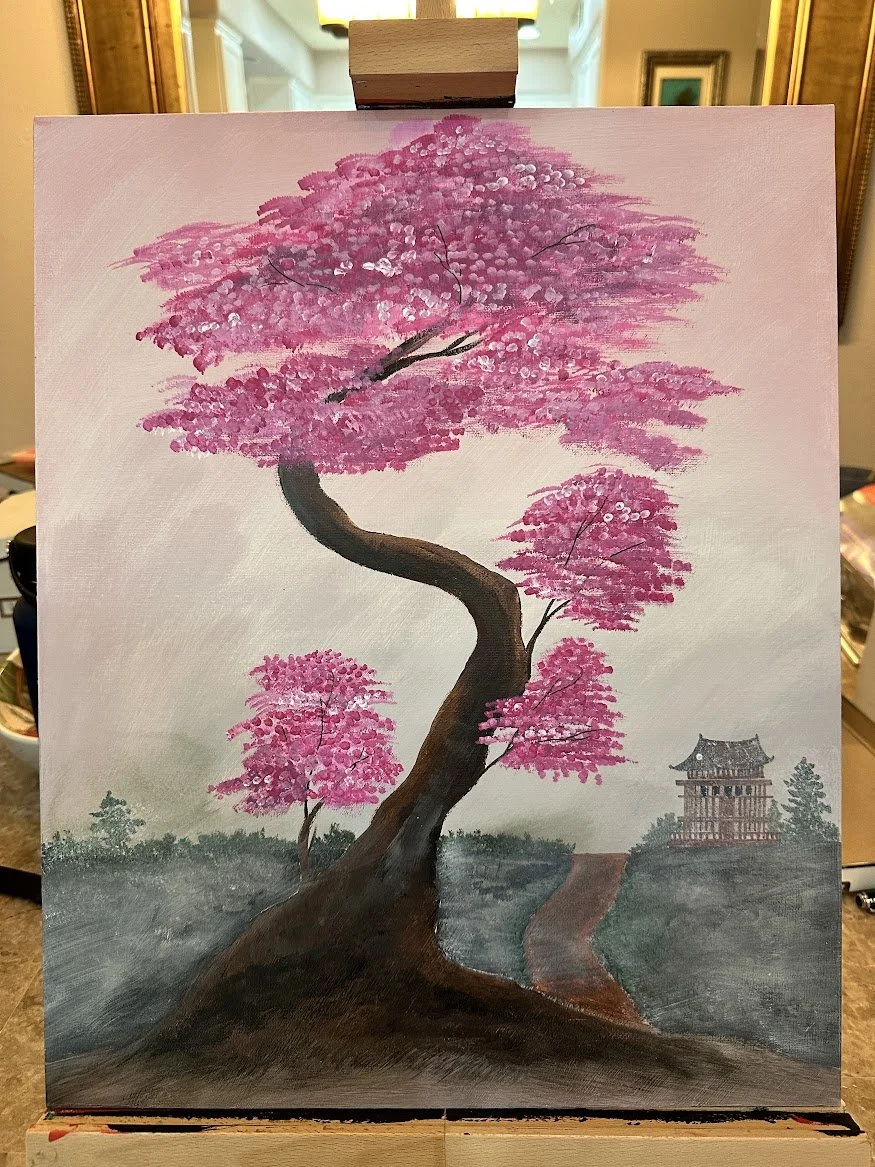 “A sweeping cherry blossom tree rises gracefully from the earth, its pink petals drifting into a soft mist. The winding path and distant temple create a sense of calm journey—a quiet moment suspended between nature and tradition.” - painting by Neil 