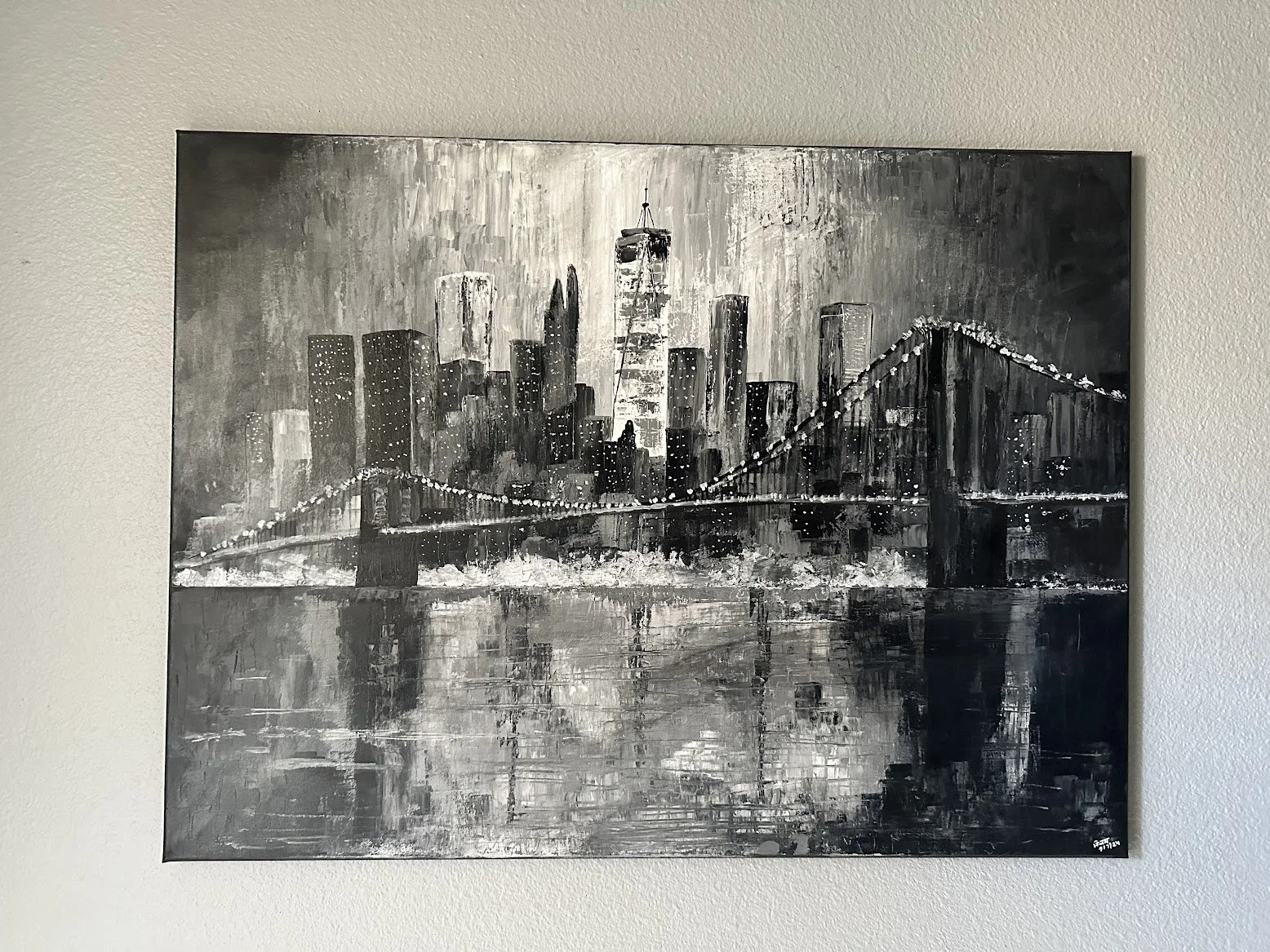 “A grayscale rendering of New York’s skyline and bridge, illuminated by rows of city lights. The textured brushwork and mirrored reflections create a sophisticated, contemporary take on the city that never sleeps.” - painting by Neil Banerjee