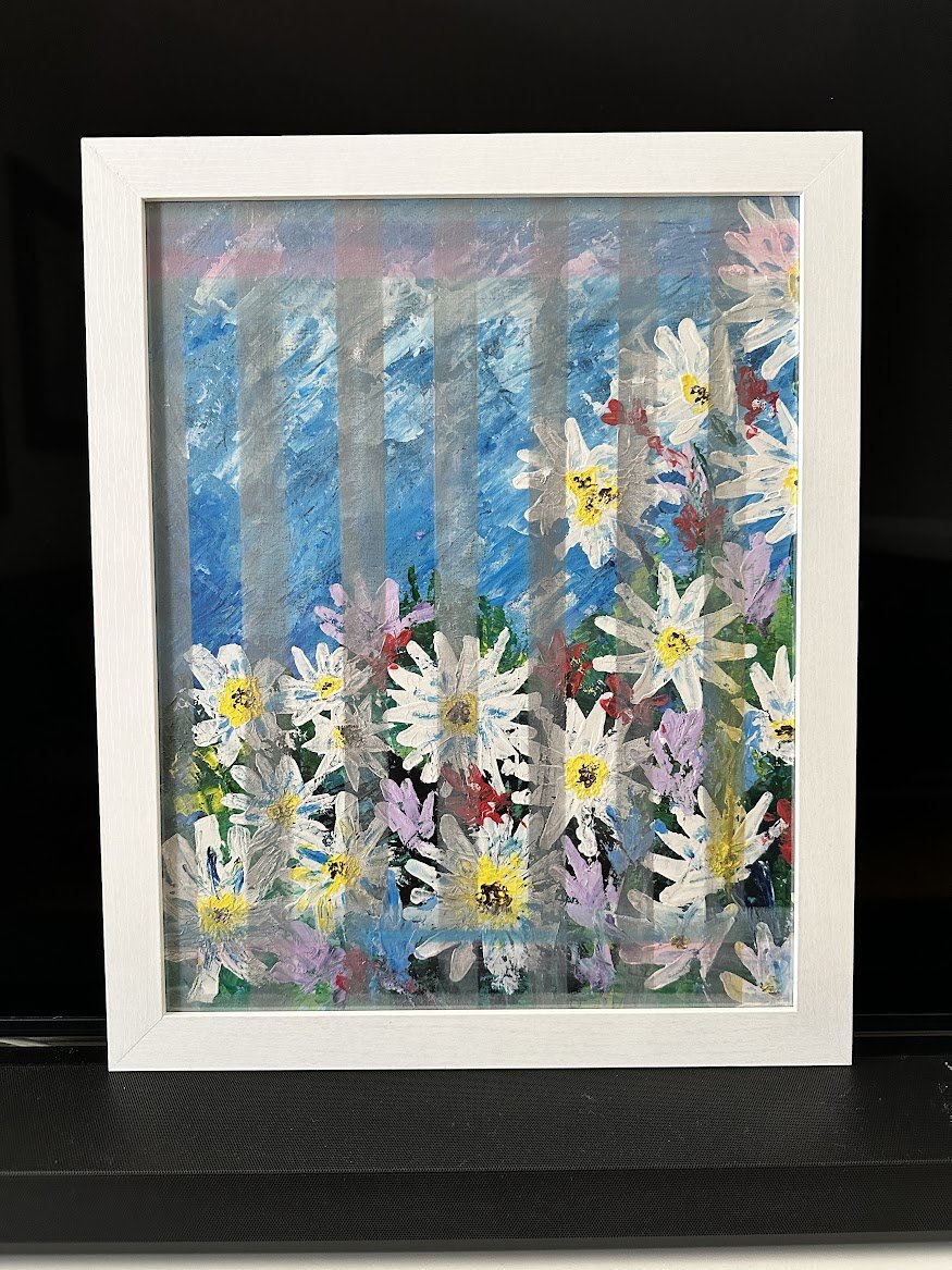 “A burst of white and lavender wildflowers dances beneath a sky-washed backdrop. Light filters through layered strokes, giving the piece a gentle, almost ethereal quality—like a memory of a garden in early spring.”- painting by Neil Banerjee