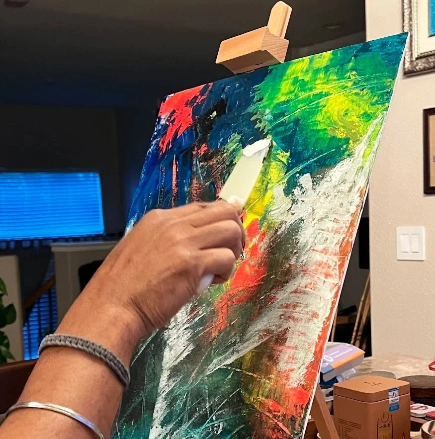 Neil Banerjee painting an abstract canvas in his studio