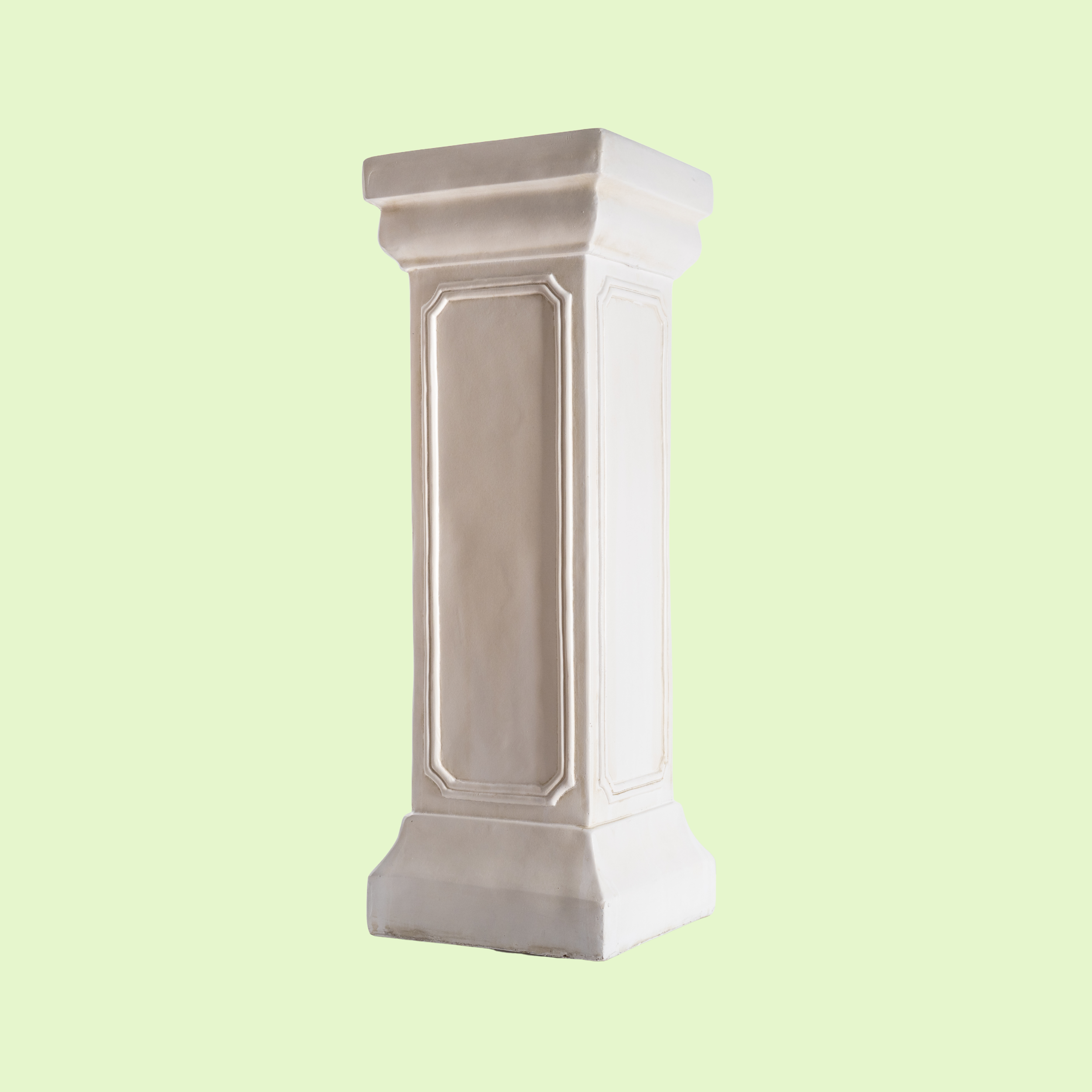 White decorative pedestal or column with molding details on a light green background.