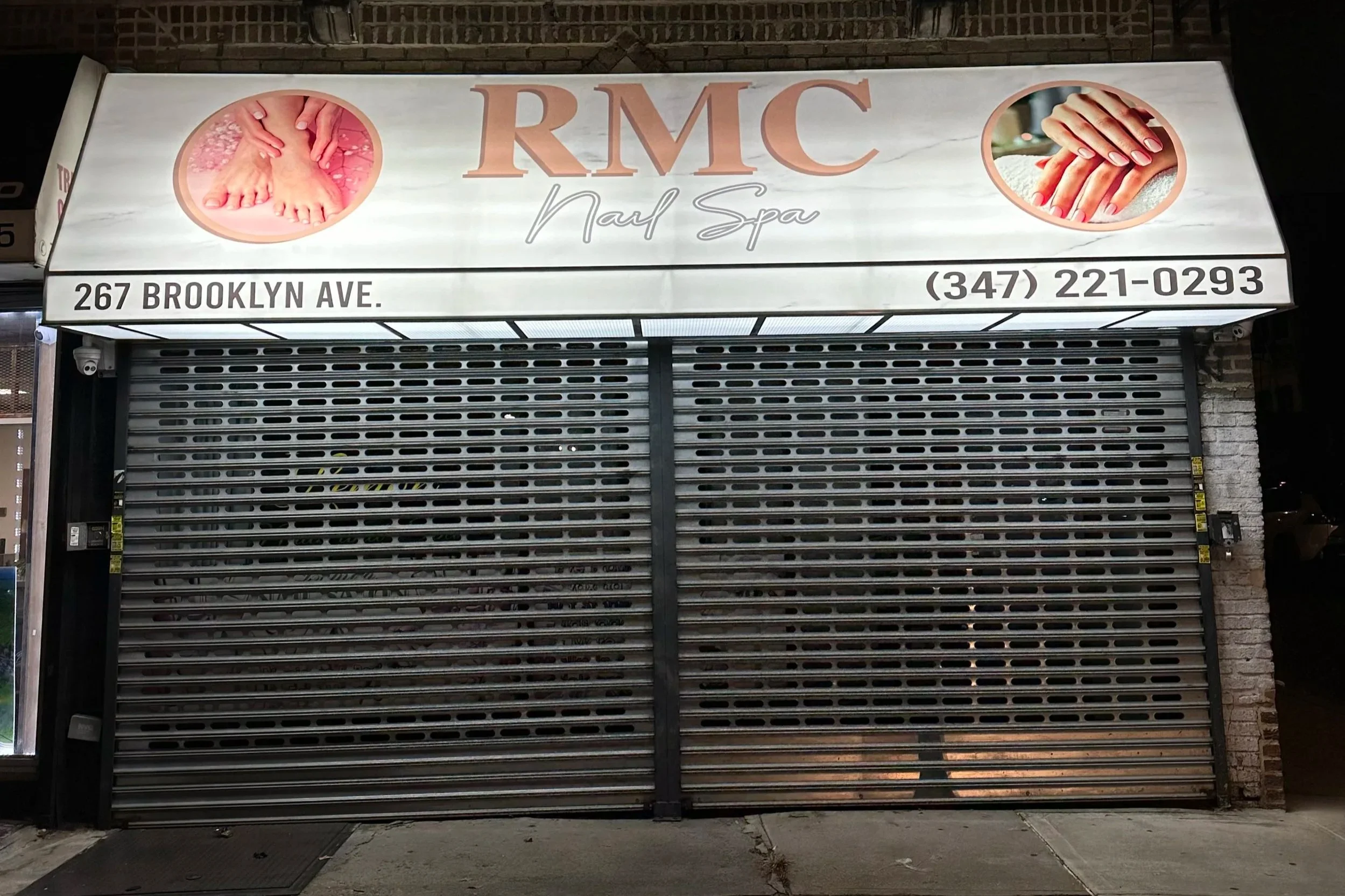 Closed storefront with a sign for RMC Nail Spa, located at 267 Brooklyn Ave. The sign features images of well-groomed hands and feet, along with the spa's phone number (347) 221-0293.