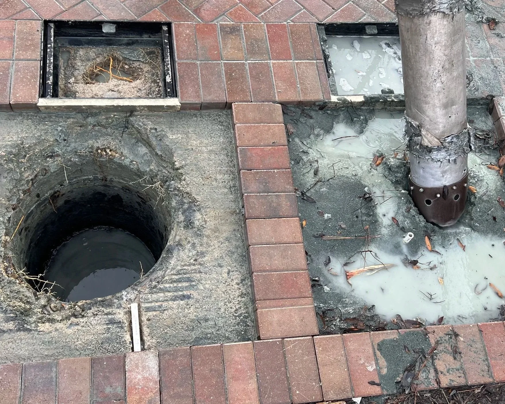 Vacuum extraction removing debris, sand, and buildup from a catch basin to prevent flooding.