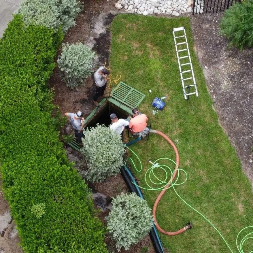 Overhead view of a stormwater team cleaning and inspecting a large drainage basin at a residential community in Bonta Springs.