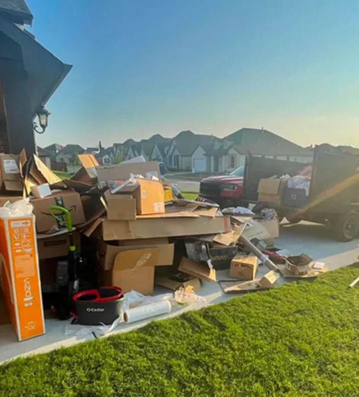 Curbside pile of boxes and household items ready for pickup during estate cleanout in a New Haven County suburb