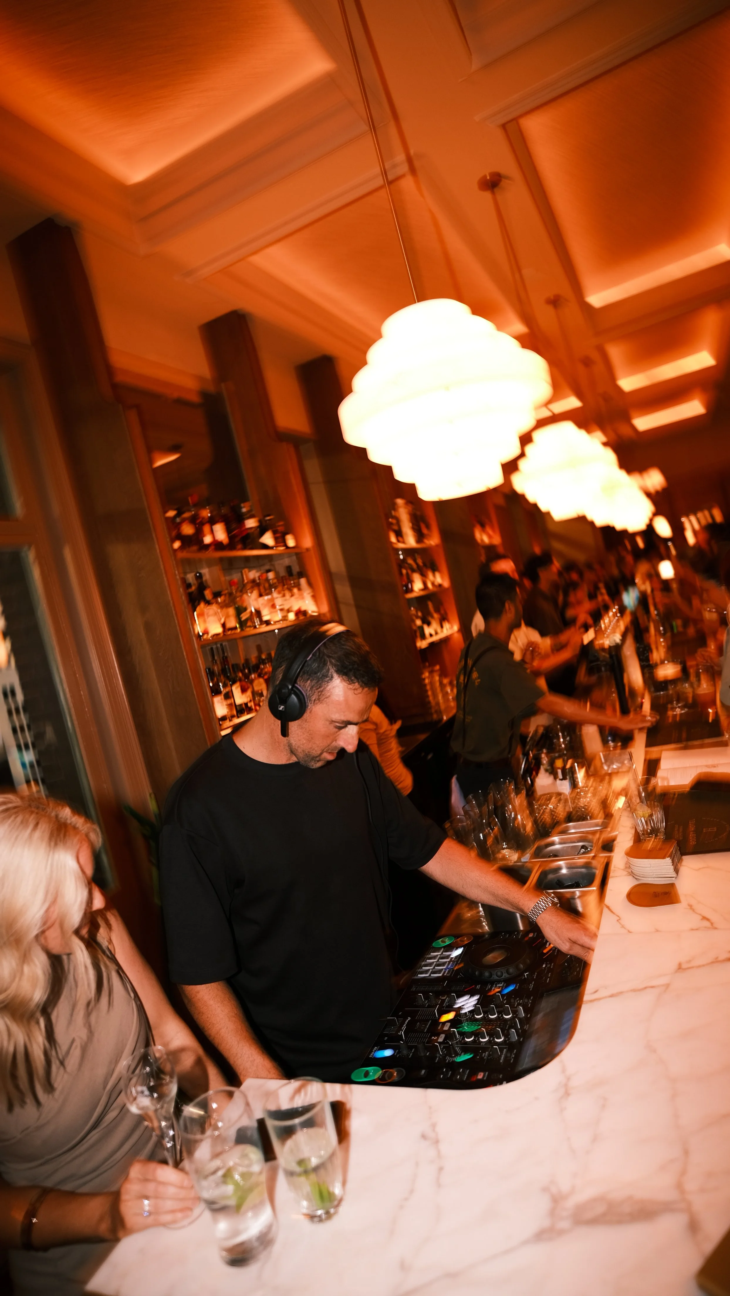 Group of friends enjoying a meal and drinks at a restaurant during a lively gathering.