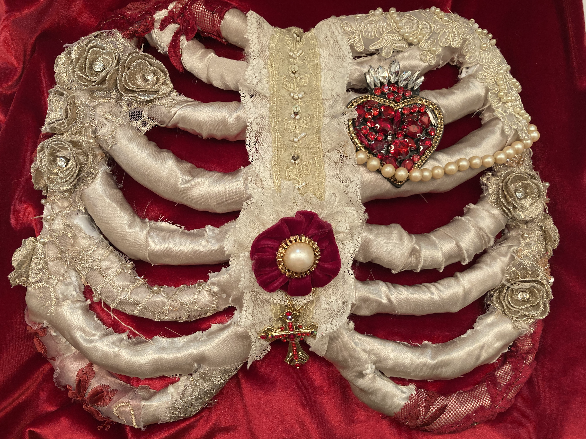 Ribcage close-up. Wrapped in ivory satin and embellishment tacked on