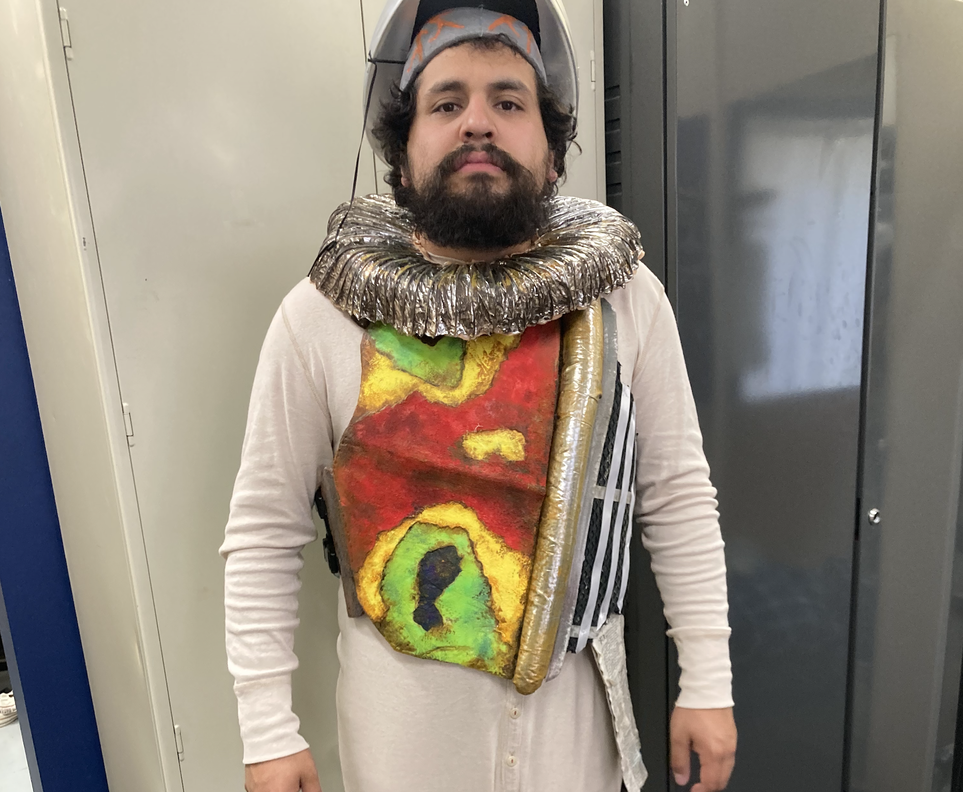 Quixote fitting, Front of chestplate, neck ruff and bedpan helmet. Ruff made of aluminum vent hose, distressed and lined with felt.