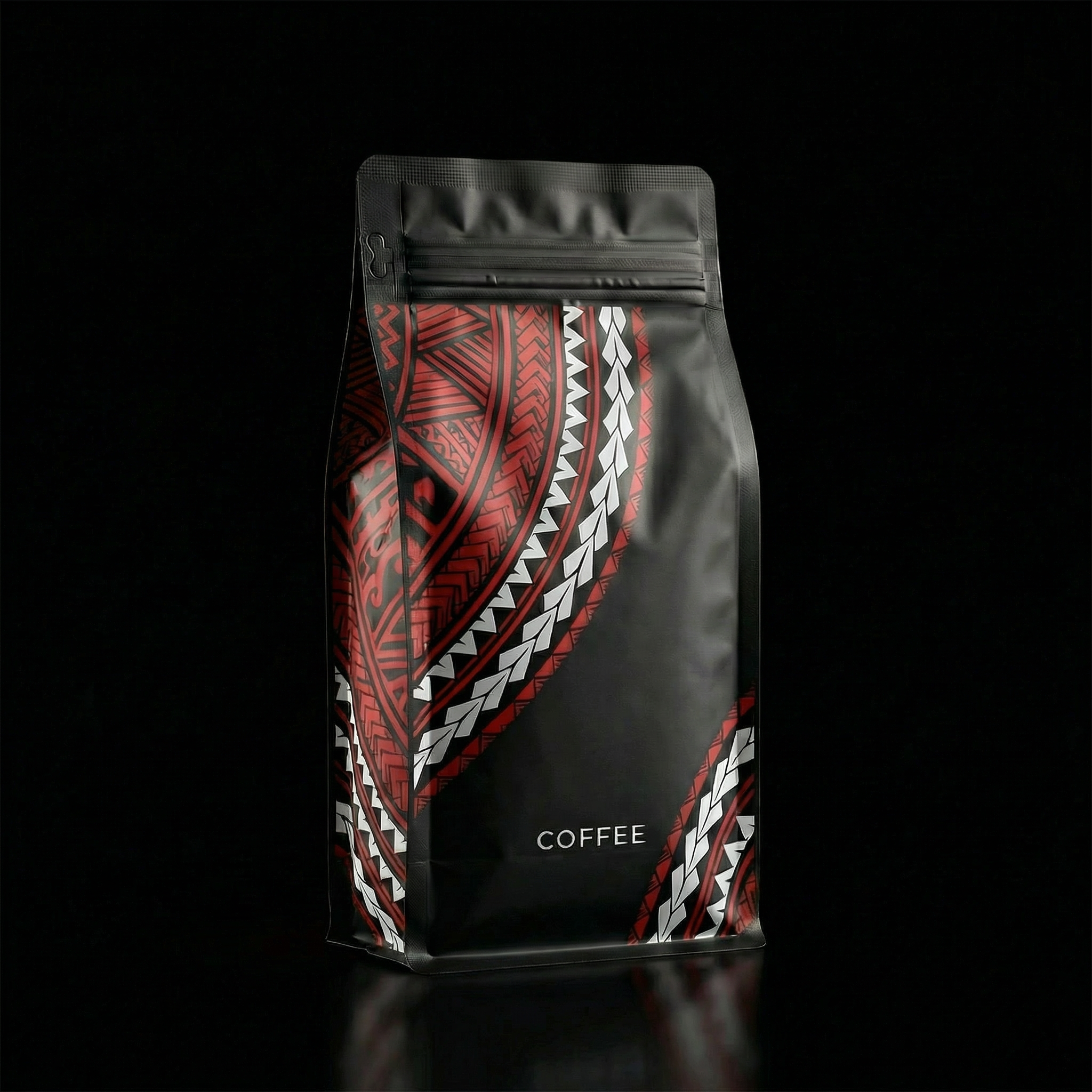 Black coffee bag with red, white, and black tribal patterns on a black background.