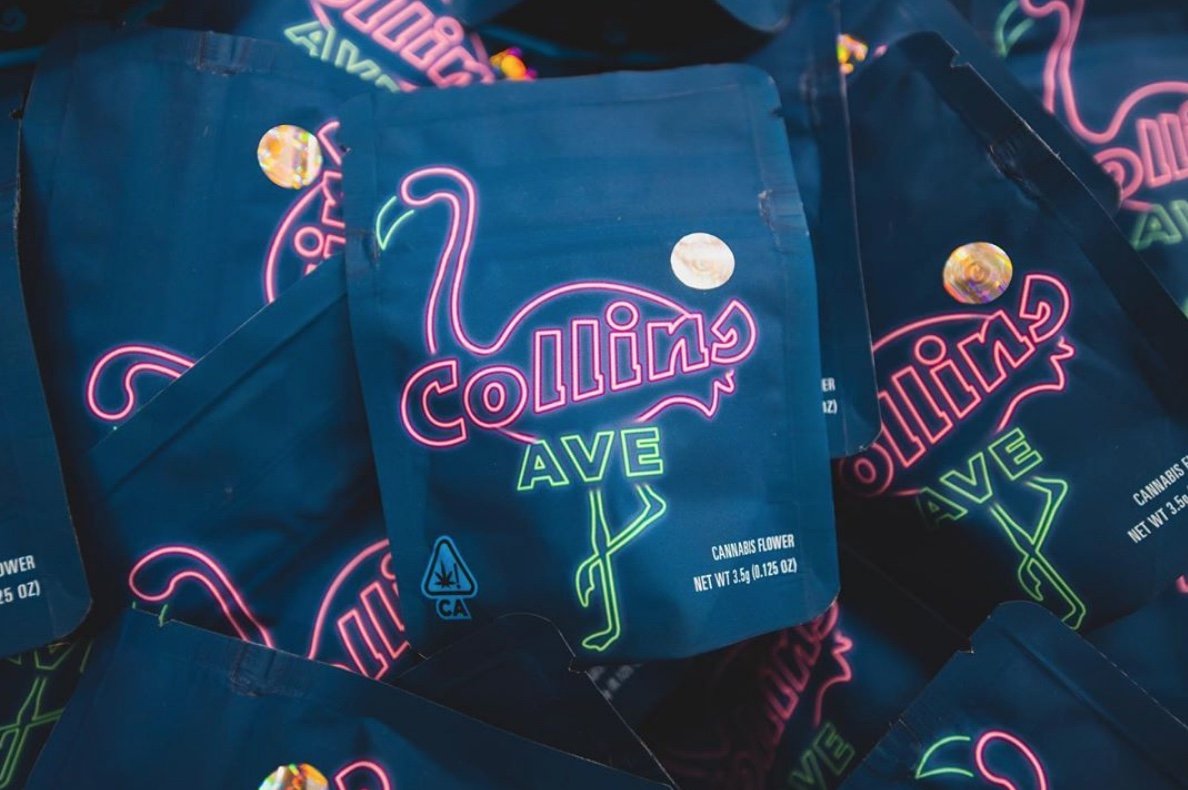 Several packages of cannabis flower labeled 'Collins Ave' with neon-style flamingo graphic on dark blue background.