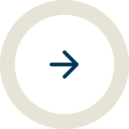 A circular button with a beige outer ring and white inner circle, featuring a right-pointing arrow in the center.