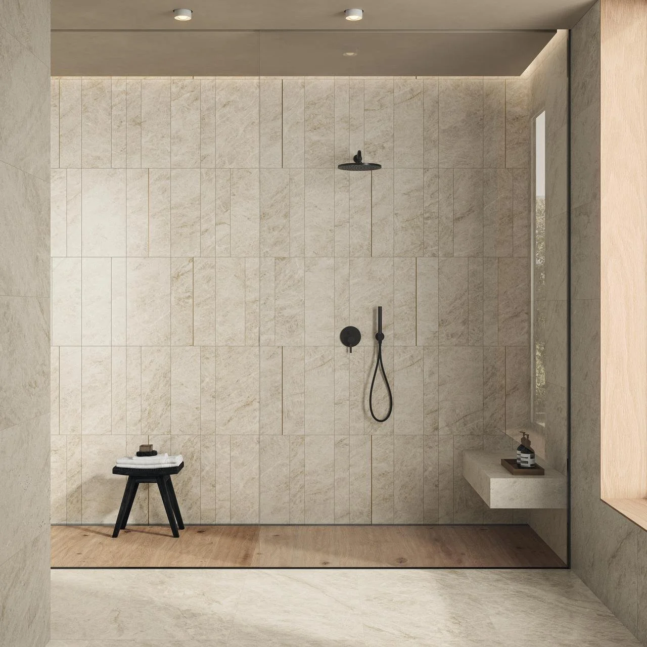 Modernin suihkukaapin sisätila, jossa on mustat suihkukiinnikkeet ja pieni musta jakkara, jossa on pieni_LED valaisin, krominen suihkukatkaisin ja kaappi.