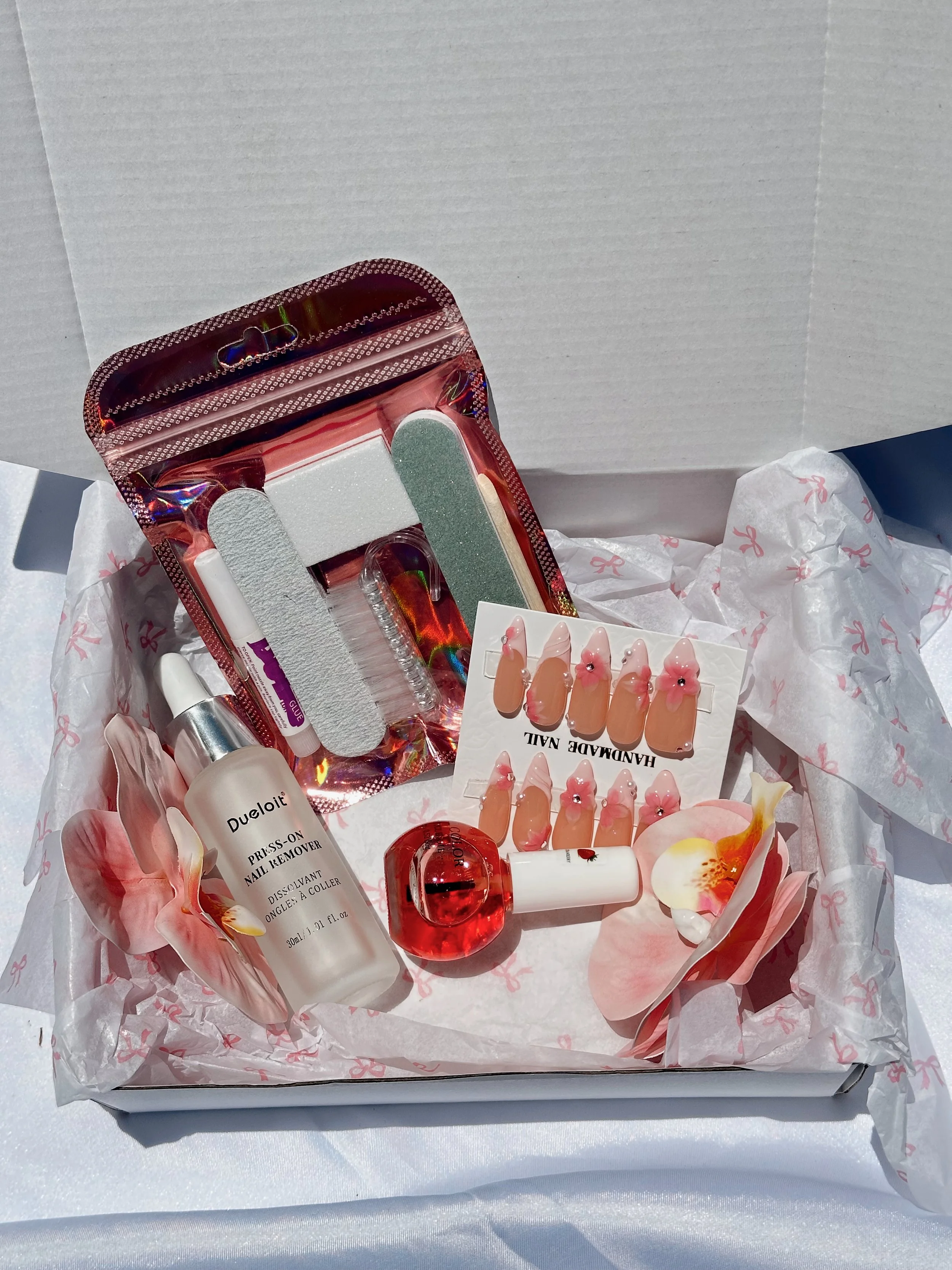 Nail care kit with nail files, buffer, nail glue, decorative hand crafted press on nails.