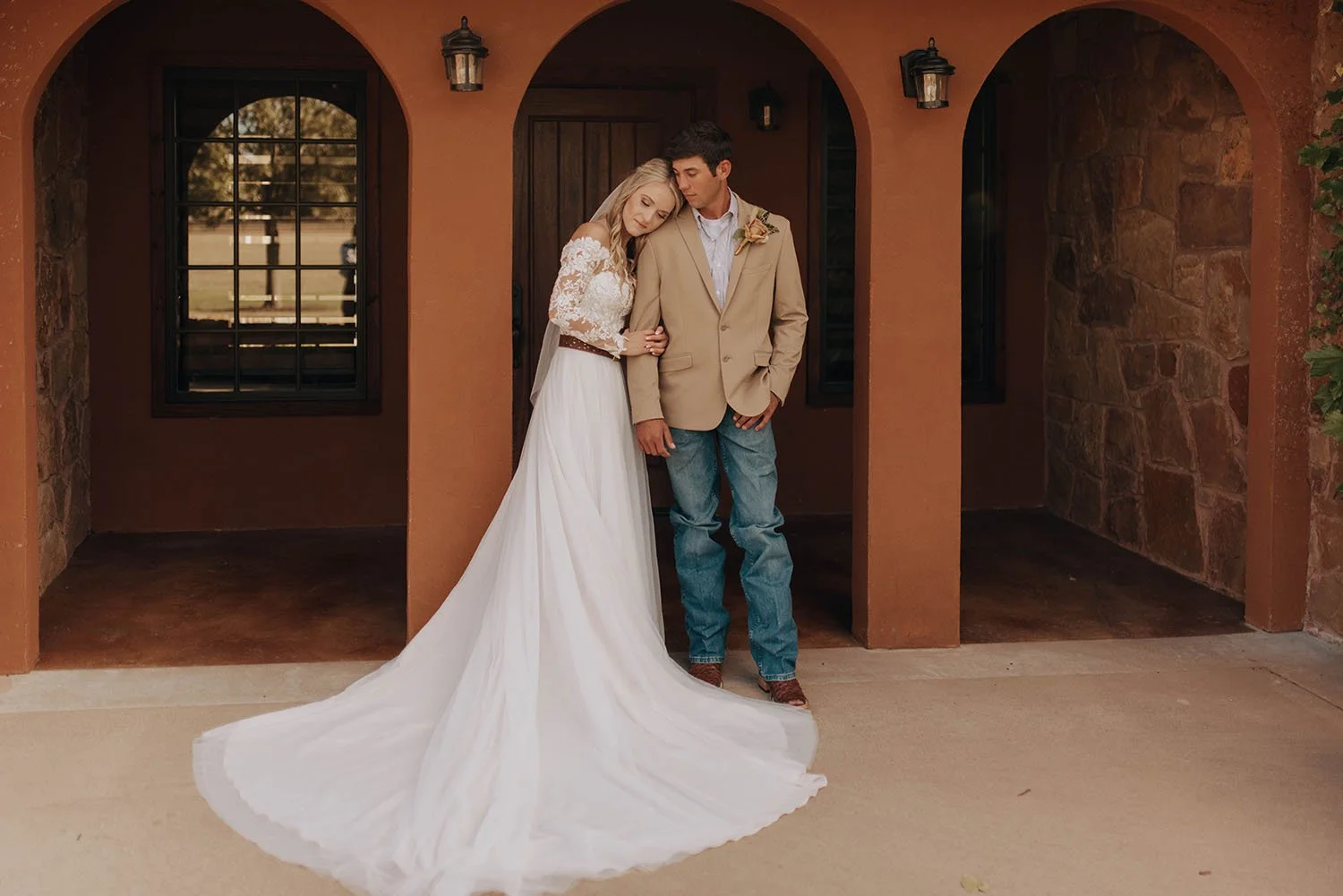 Couple under Tuscan style stucco arches