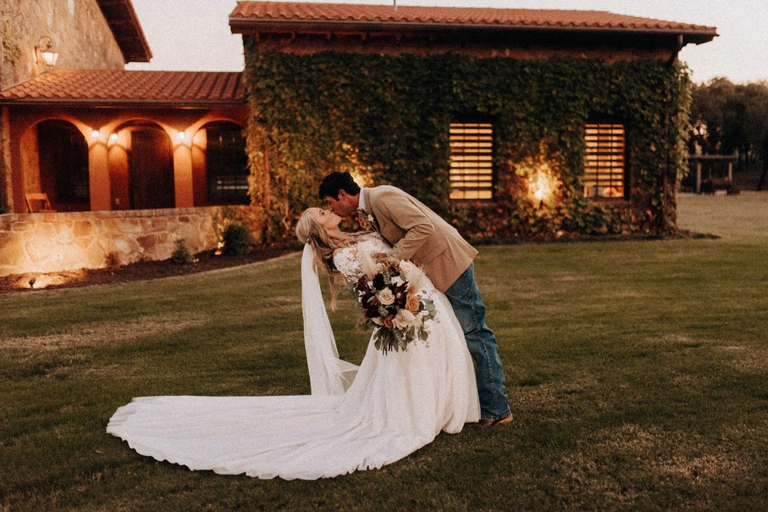 Couple kissing at outdoor wedding venue, Bella Vita Ranch