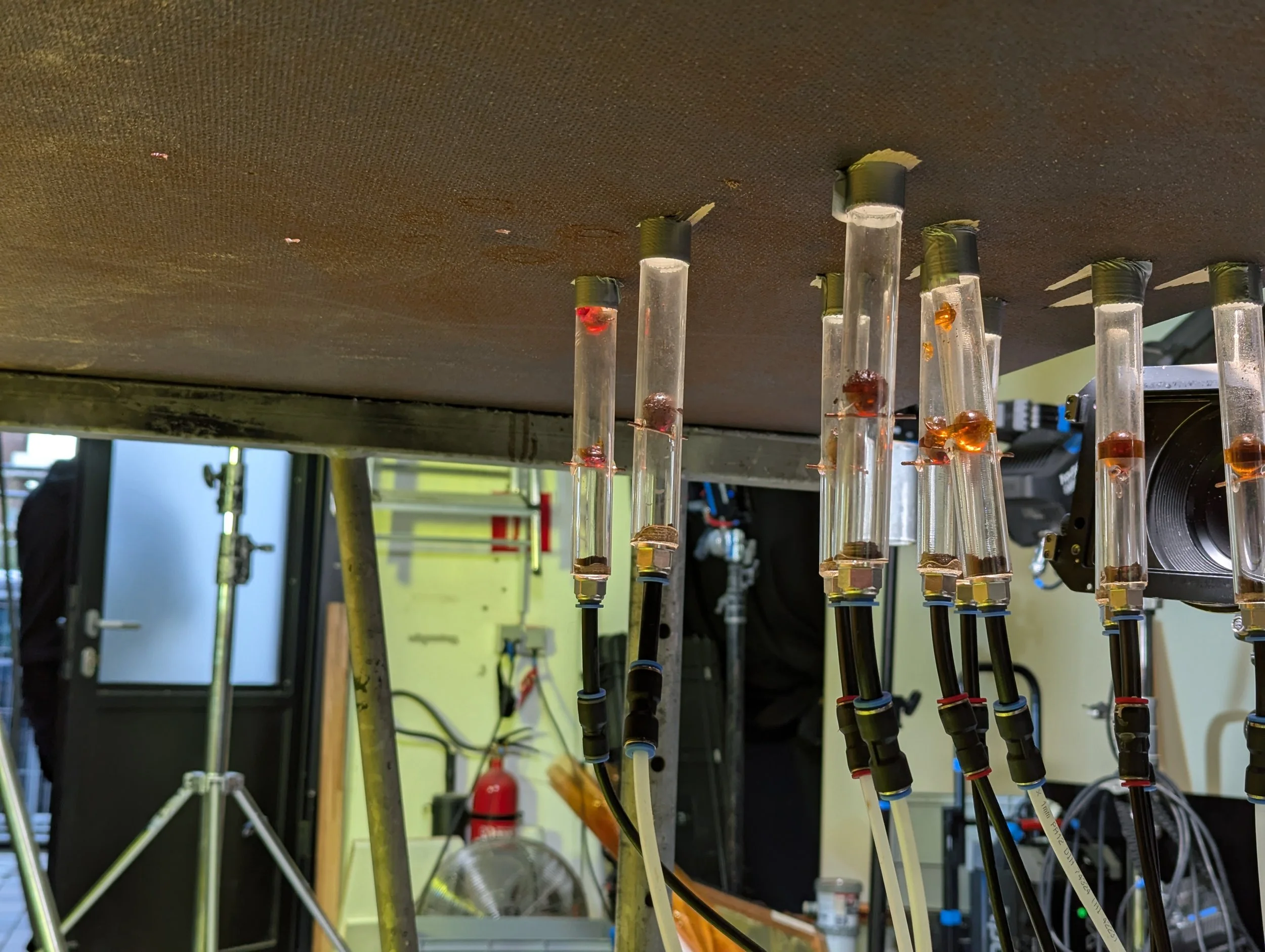 Tube with samples connected through cables in a laboratory setting.