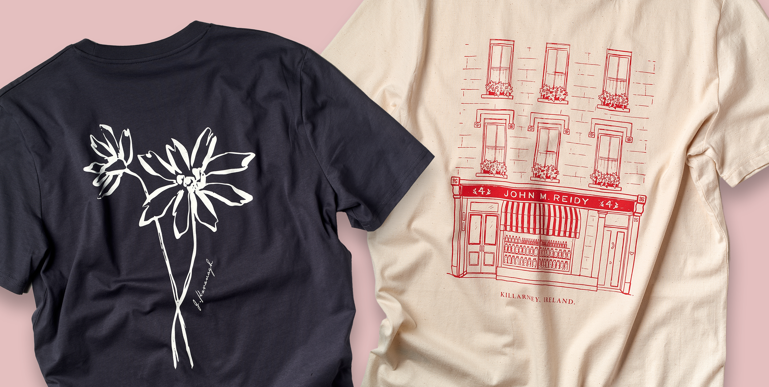 Two T-shirts screen printed by Peach street, laid flat on a pink background, one black with a white floral line drawing and the other beige with a red line drawing of a building and text about Killarney, Ireland.