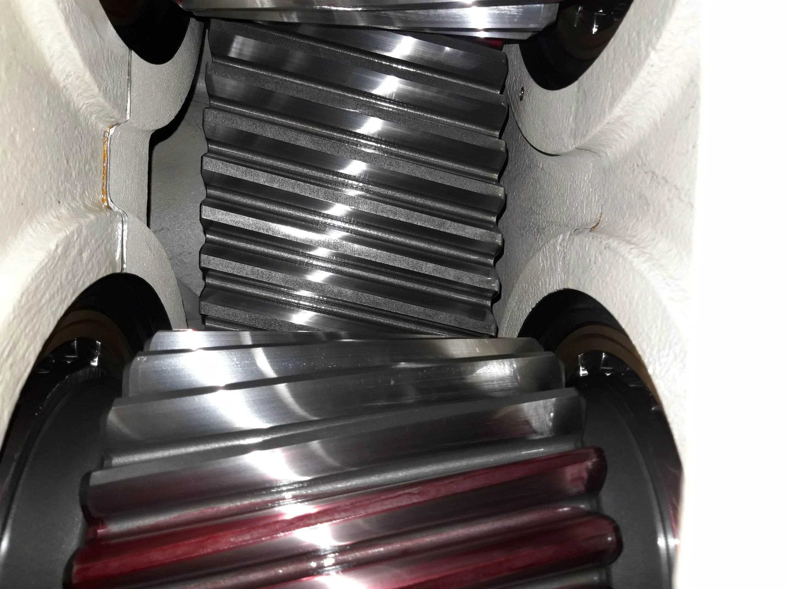 Close-up view of a large gear and the surrounding machinery inside a mechanical device.