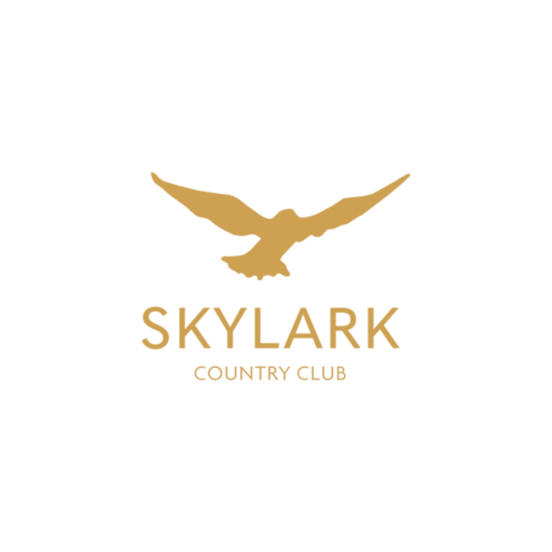 Logo of Skylark Country Club featuring a gold flying bird above the text 'Skylark' and 'Country Club' on a white background.