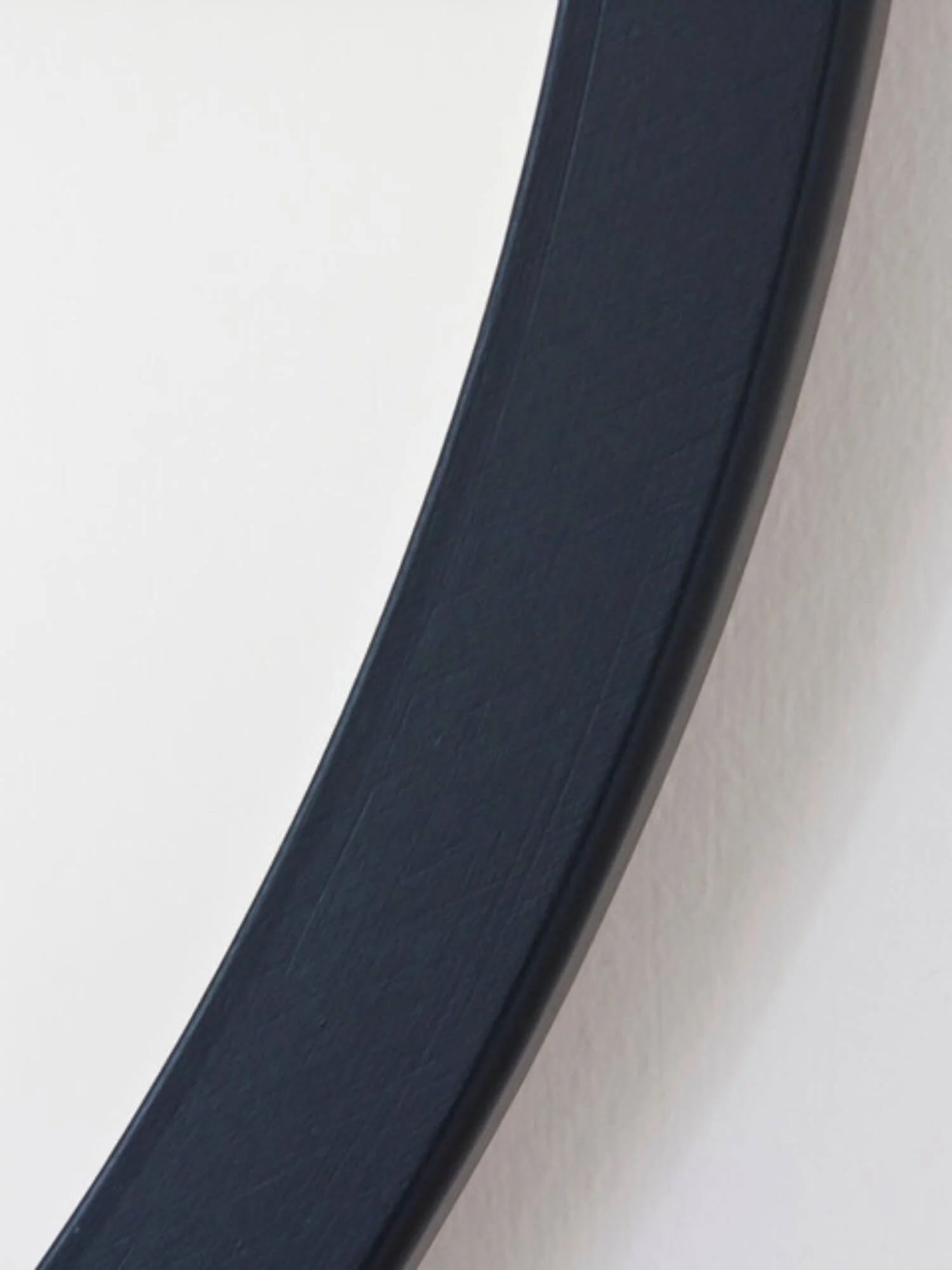 Large round black mirror frame close up