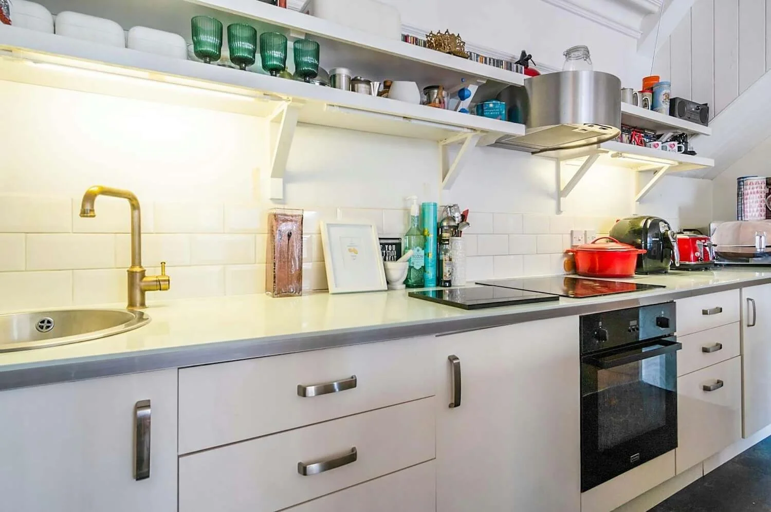 Kitchen close-up with wooden countertop, open shelves and white cabinets