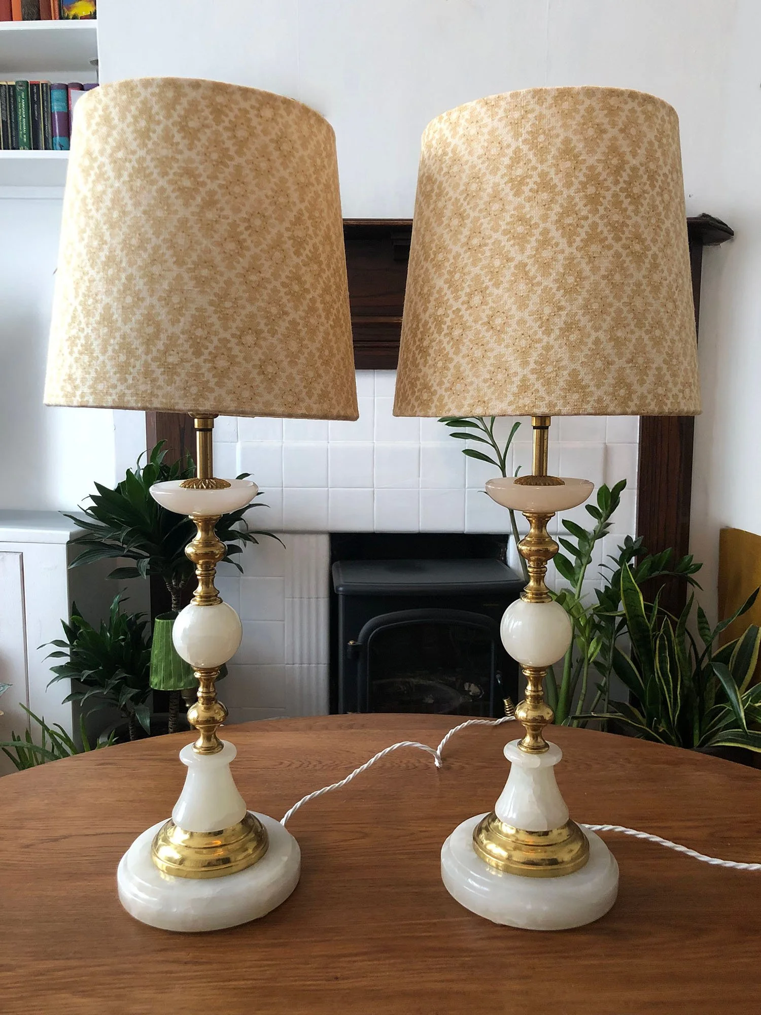 Pair of vintage marble lamps with cream patterned shades on wooden table