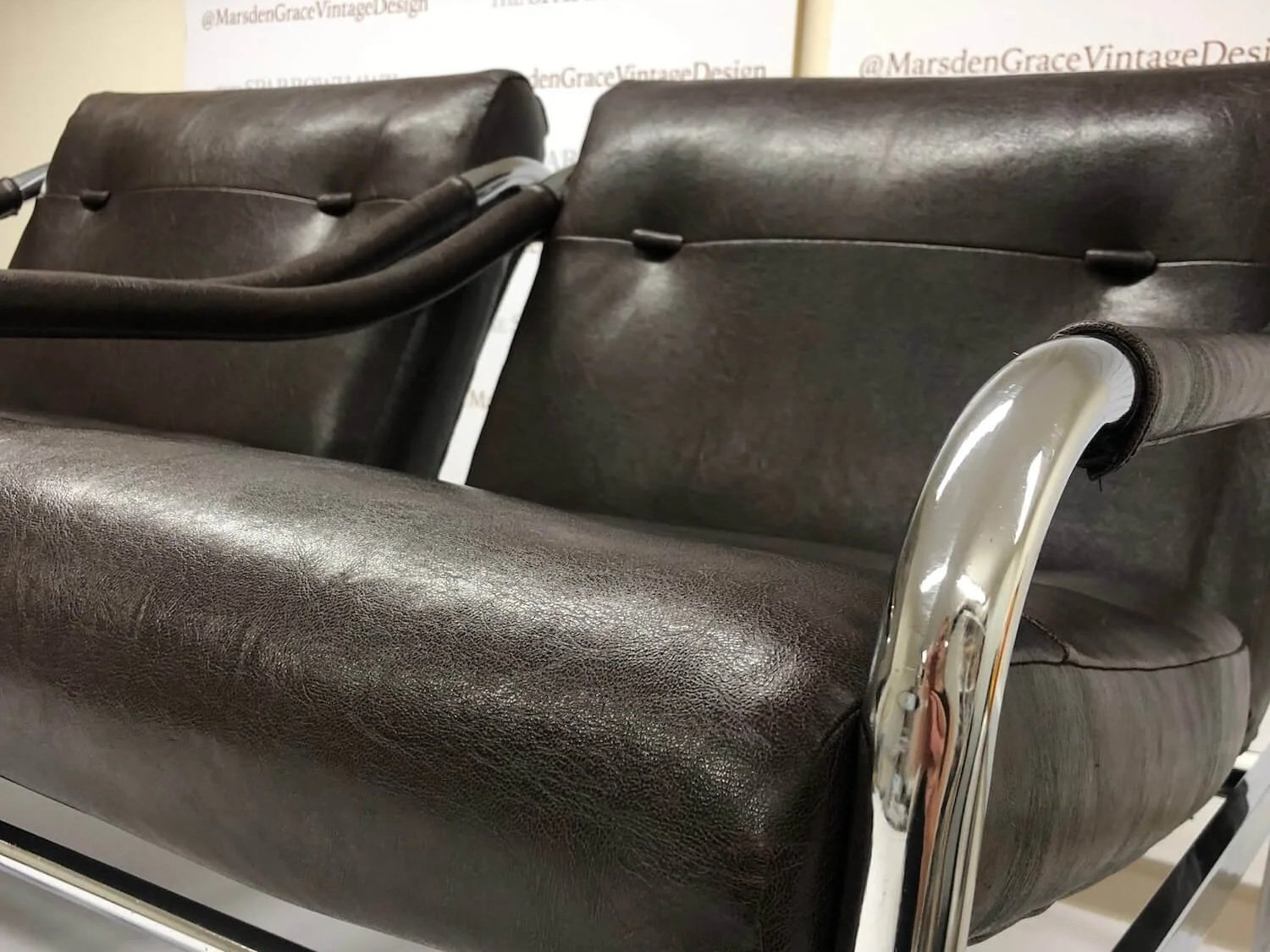 Pair of dark brown leather armchairs restored with new upholstery