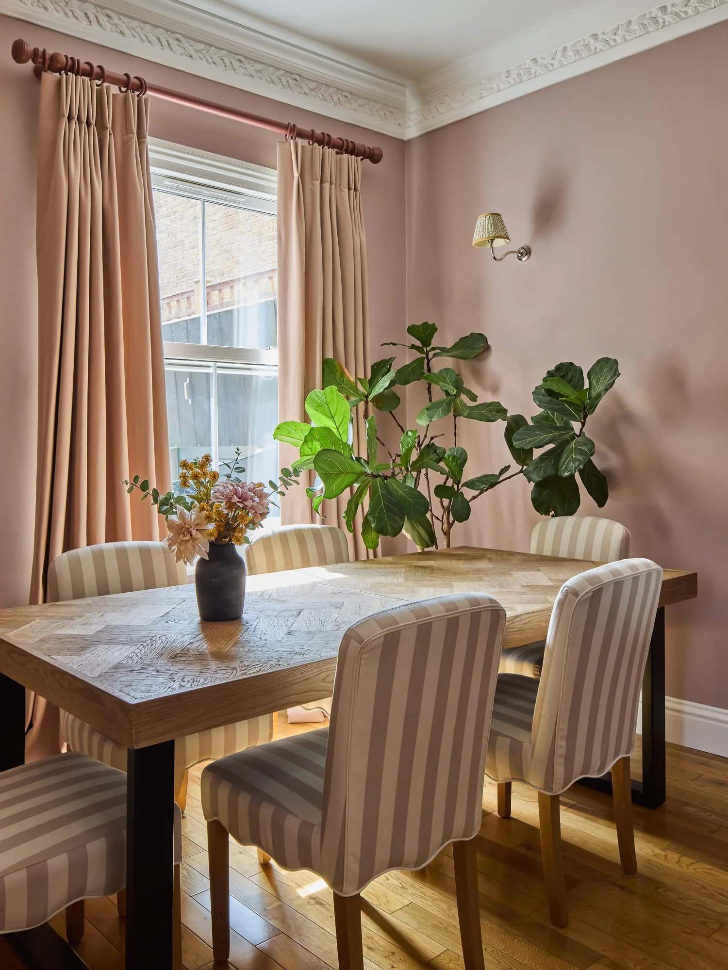 South London dining room with blush walls, bespoke curtains and oak table.