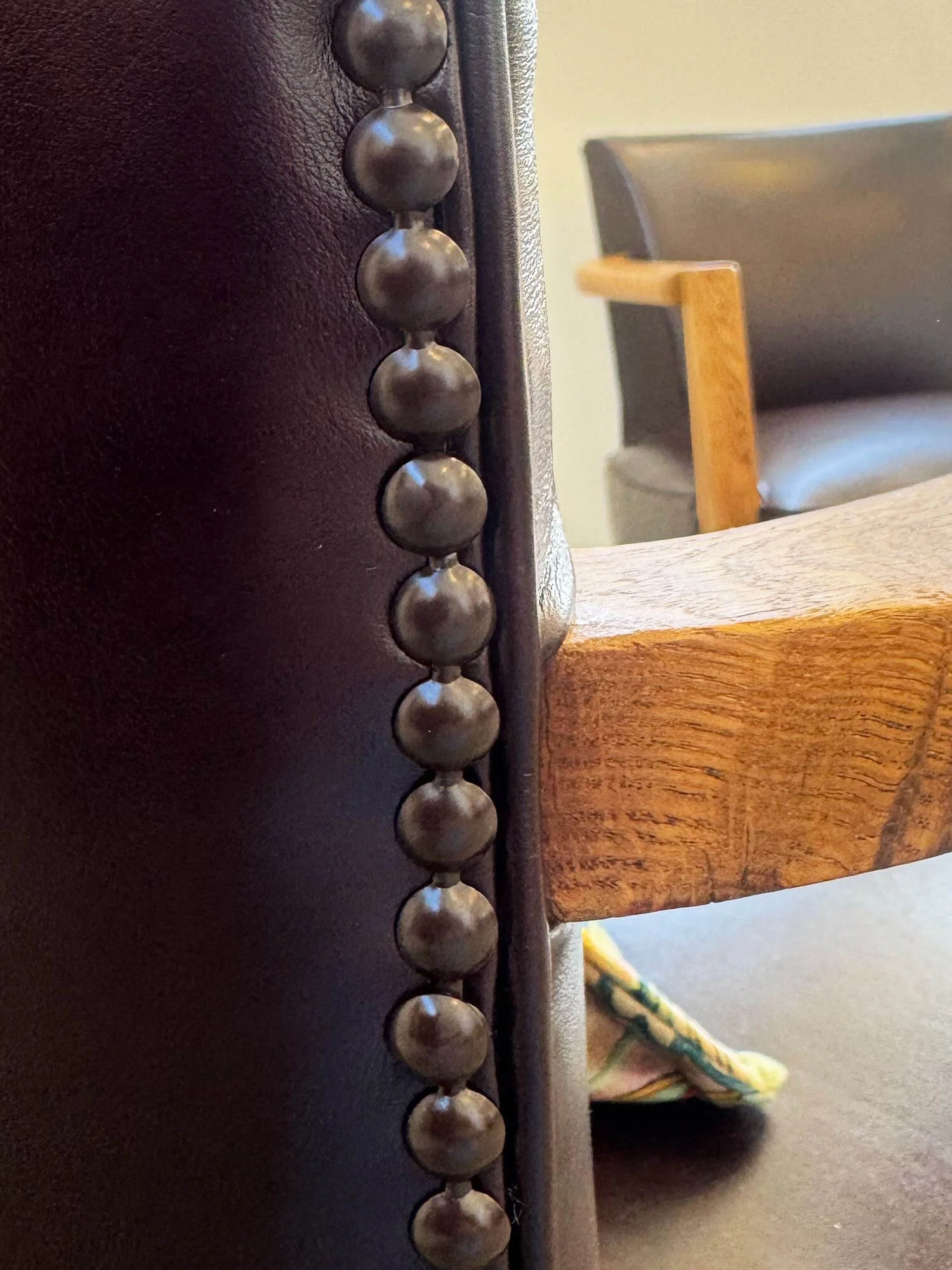 Close up of the decorative nails at the back of a French bridge chair