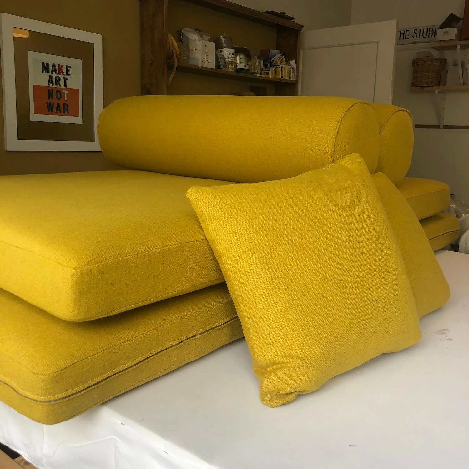 Yellow bench cushions with matching bolster pillows