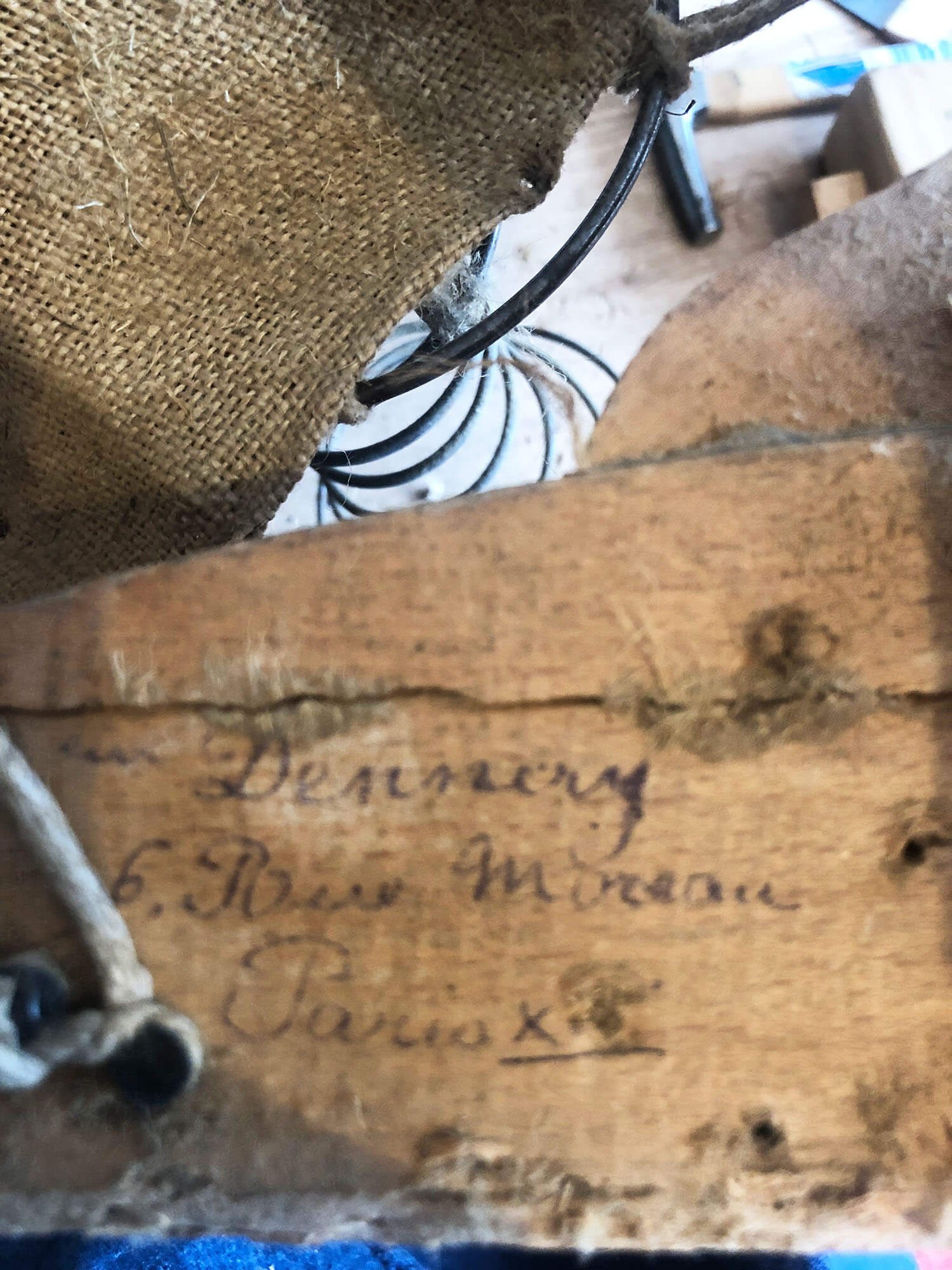 close up of the makers Paris stamp on the internal frame of a bridge chair