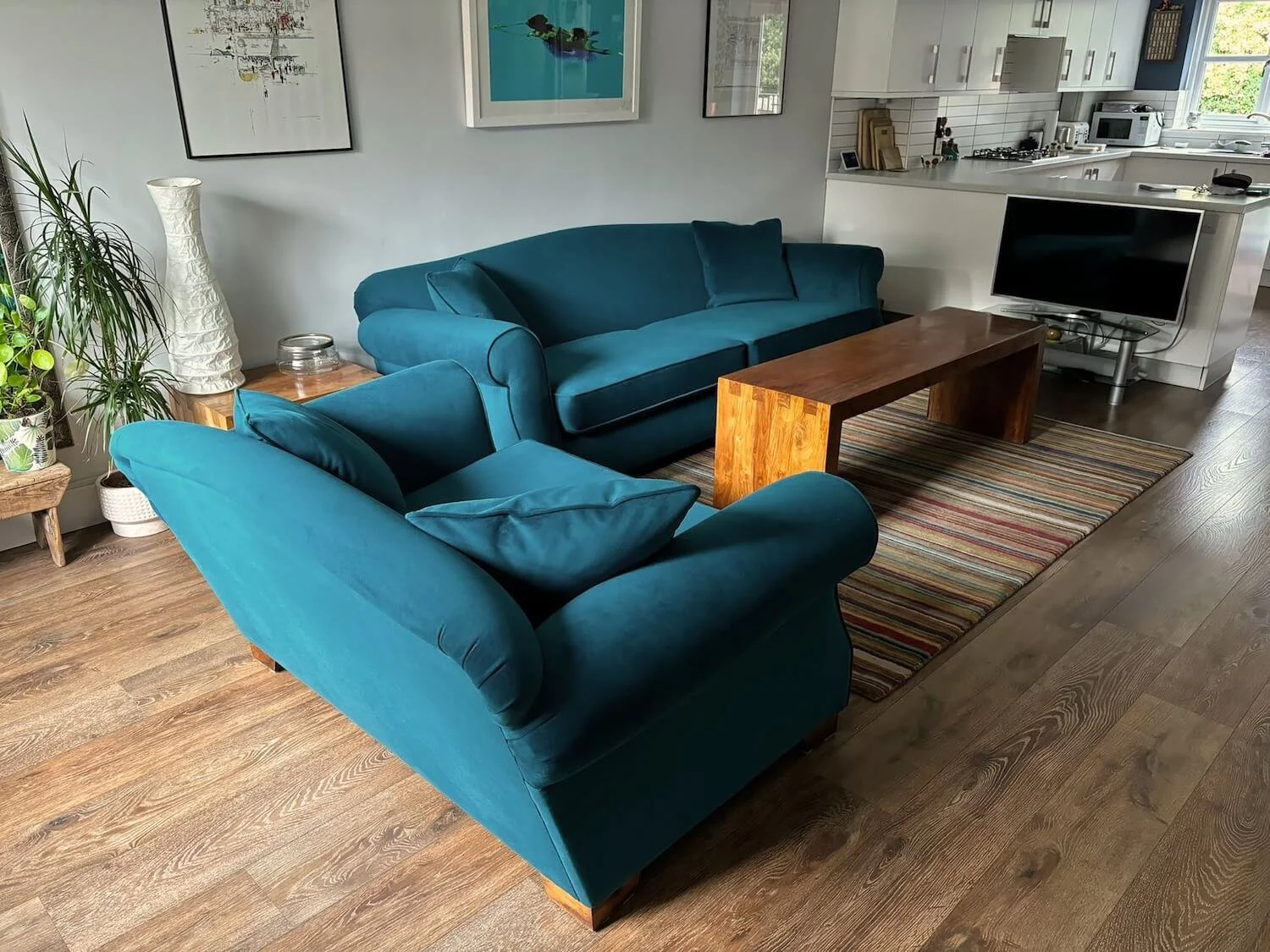 Teal contemporary sofa in modern living room with patterned rug