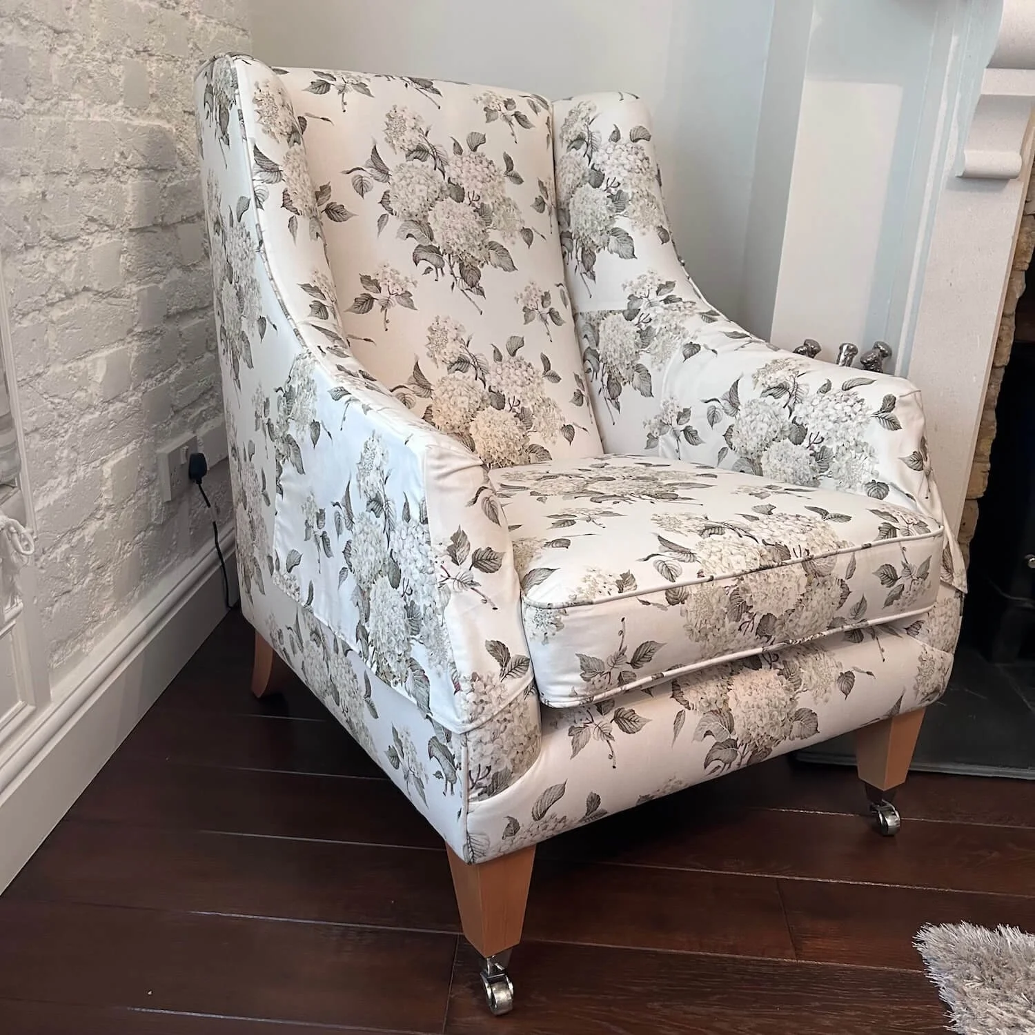 Floral-patterned contemporary armchair in light neutral tones
