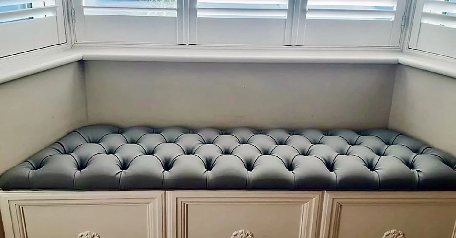 Deep buttoned window seat cushion in soft grey fabric