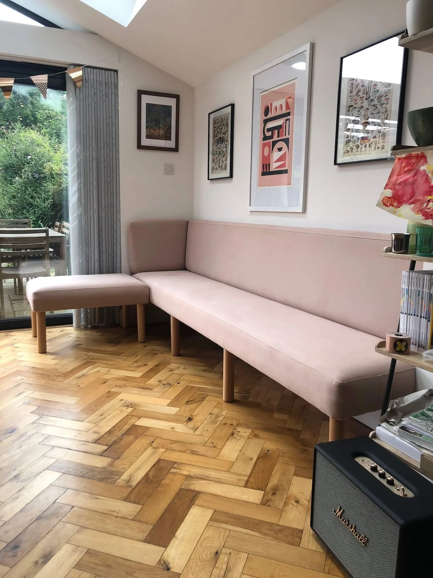 Custom pink banquette seating in open-plan kitchen and dining space