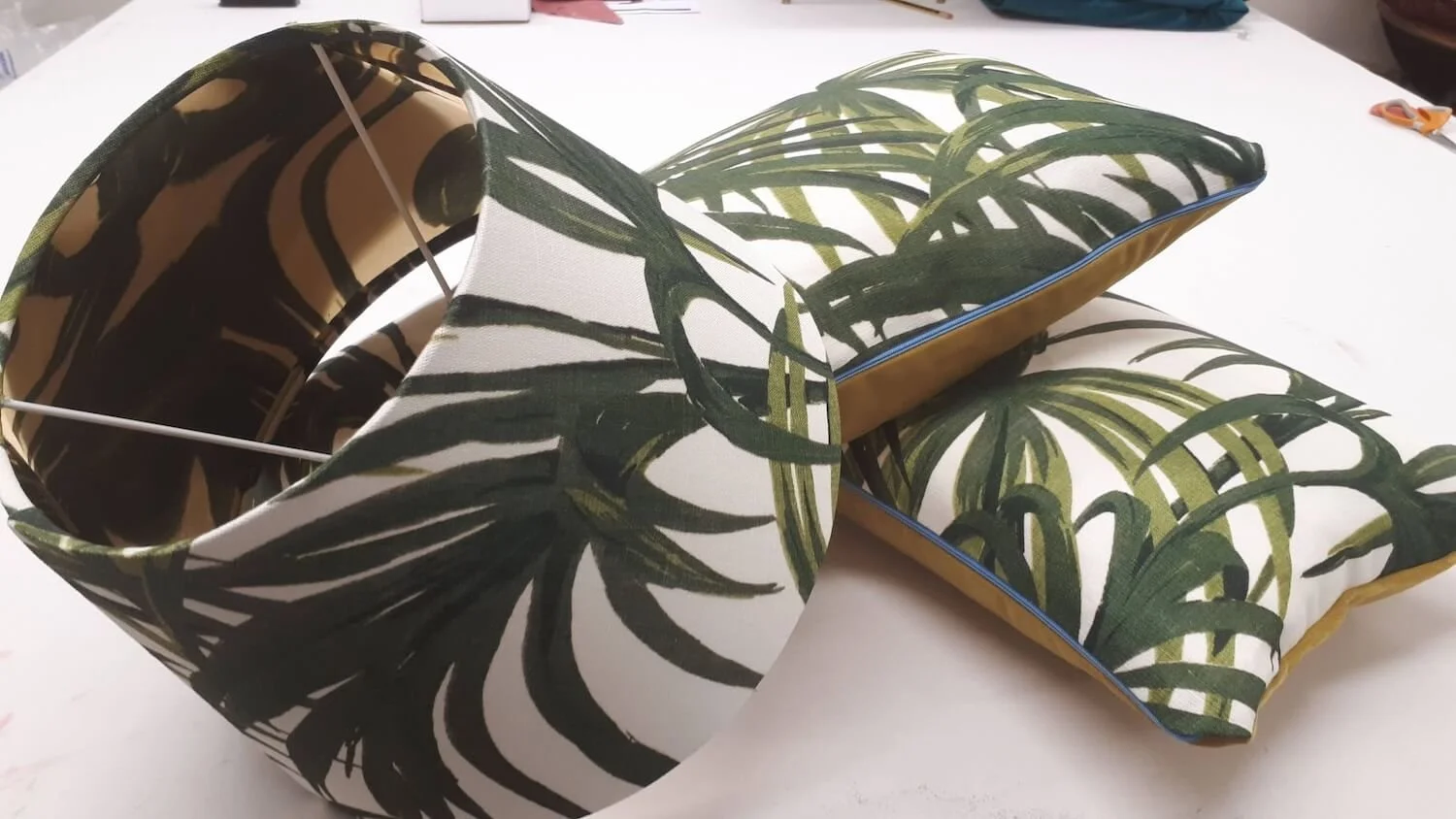 Green botanical-print cushions and matching lampshade