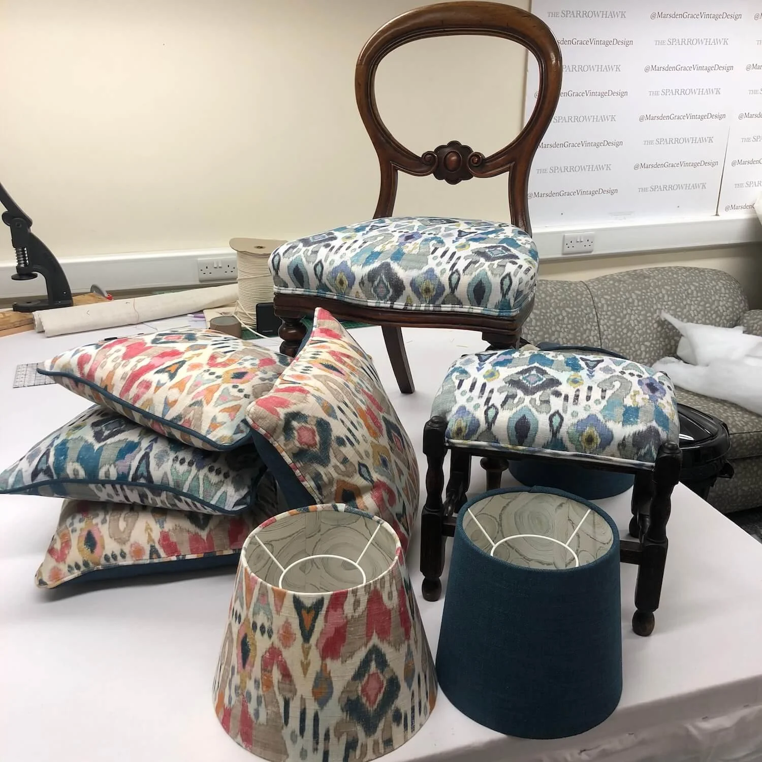 Handmade patterned cushions displayed with upholstered vintage chair