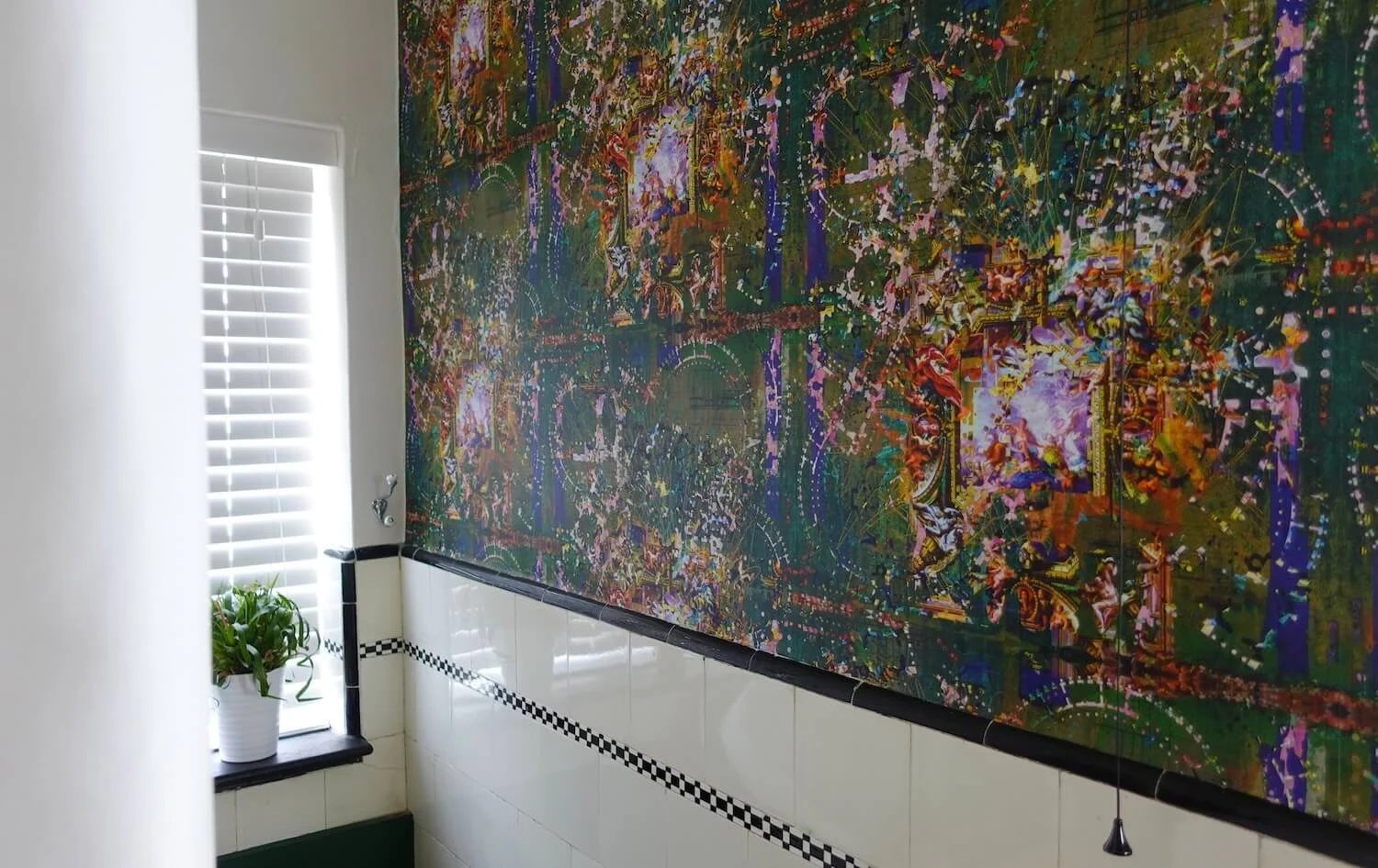 Large-scale abstract wallpaper behind bath in statement bathroom