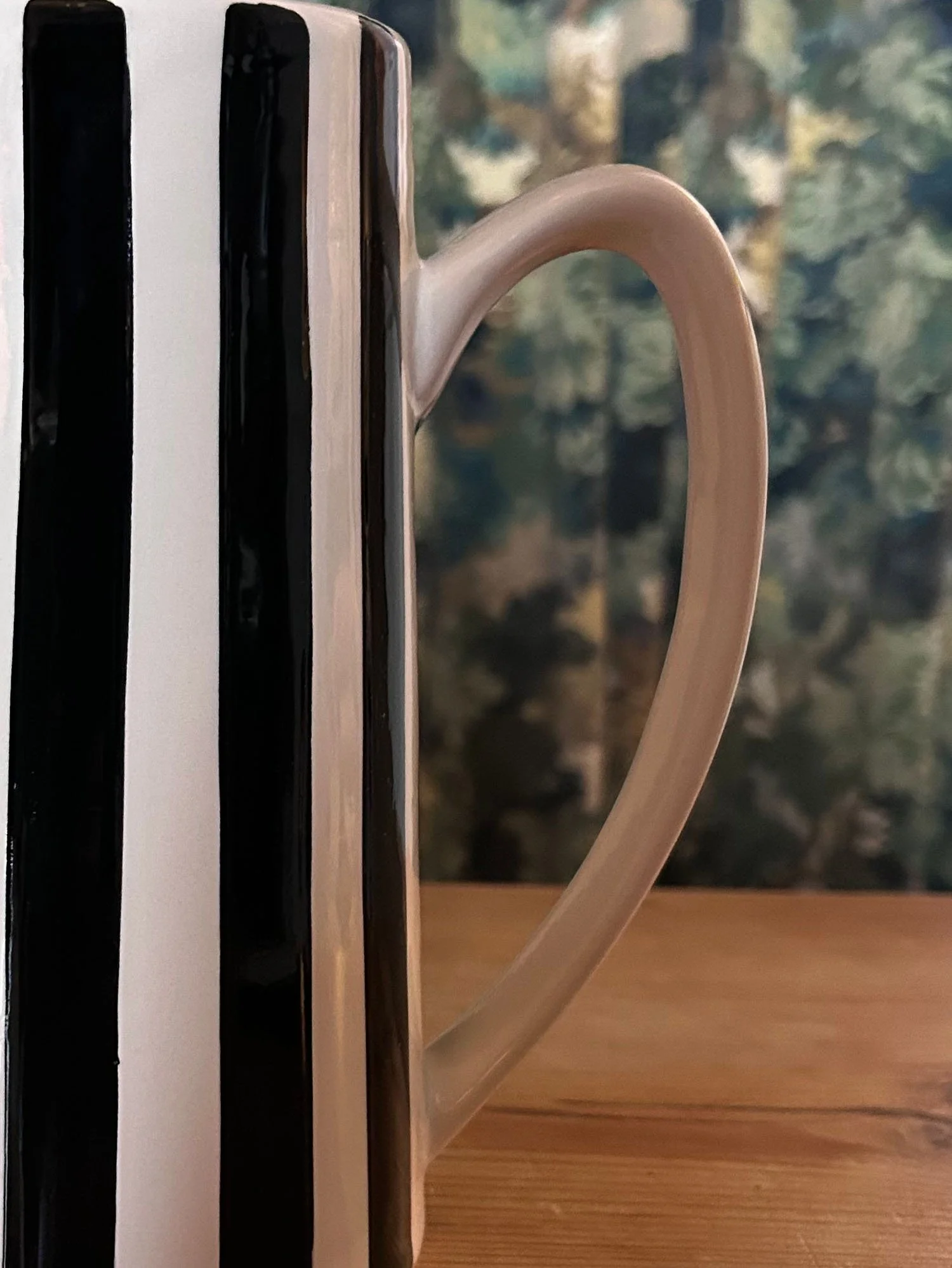 Close-up of black and white striped ceramic jug showing handle detail