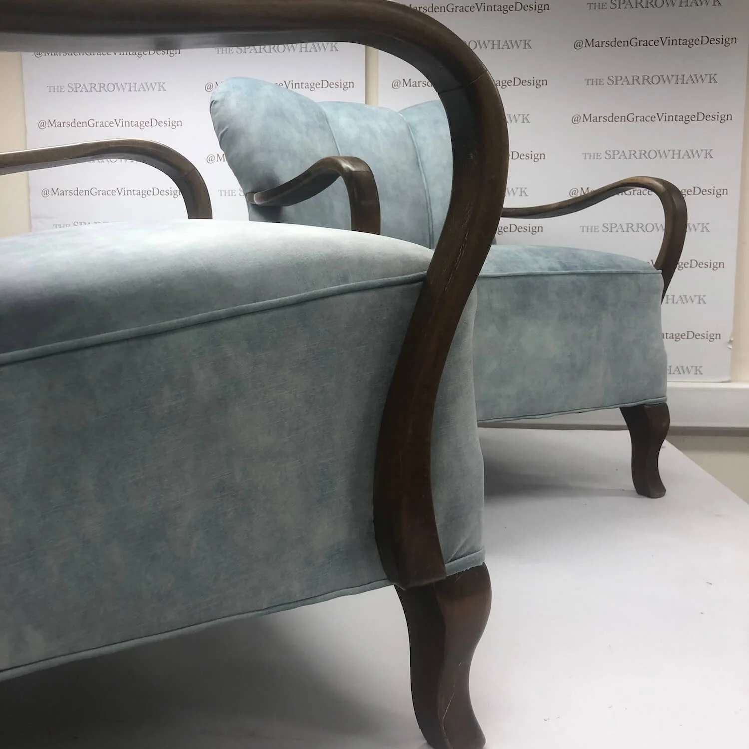 Traditional restoration on curved armchair with teal velvet upholstery