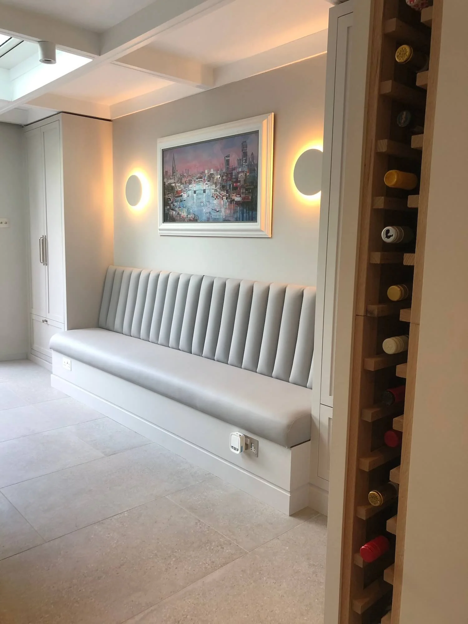 Elegant grey fluted banquette with integrated lighting in modern dining room