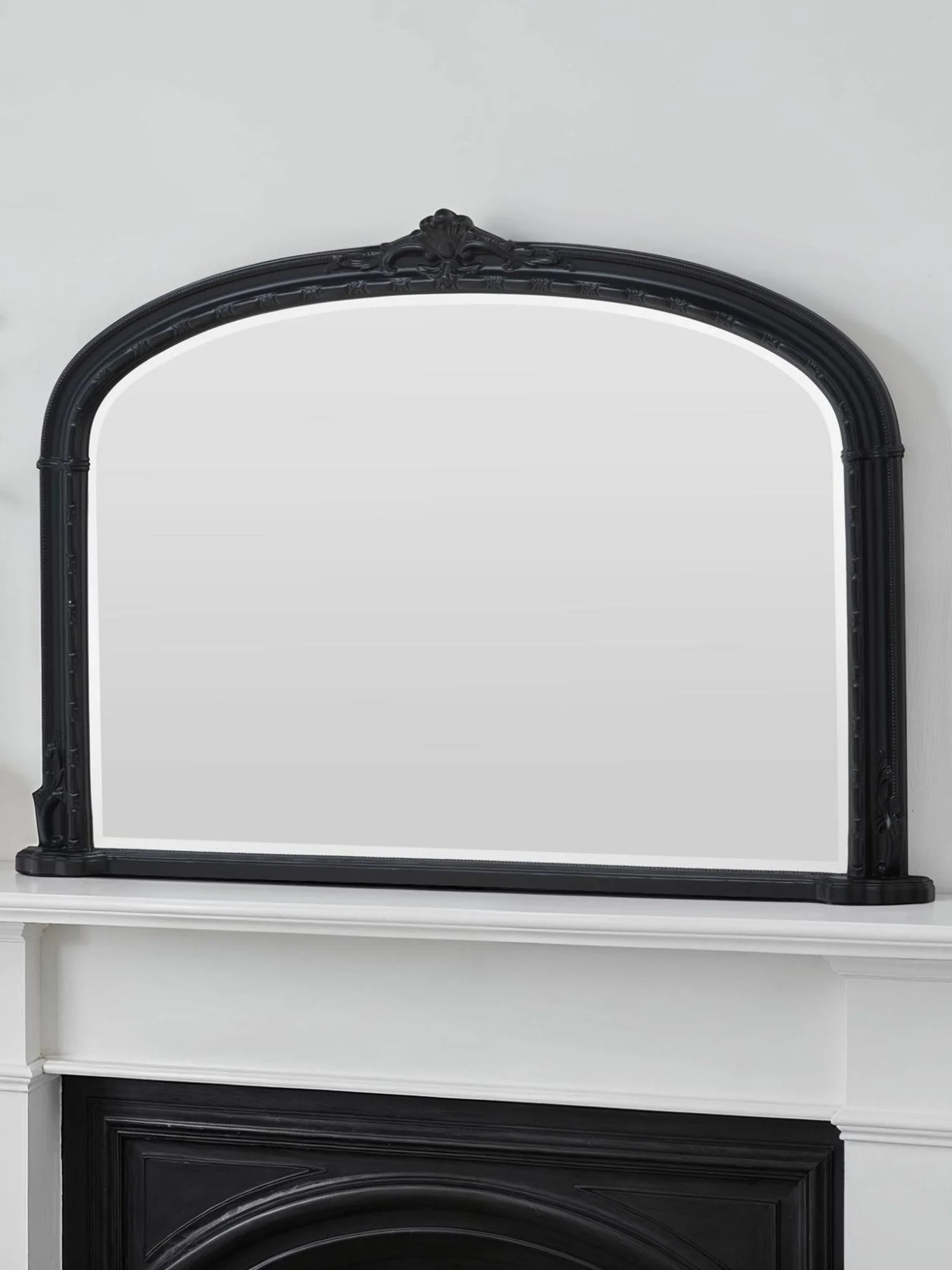 Ornate arched overmantel mirror by Yearn Mirrors London in black