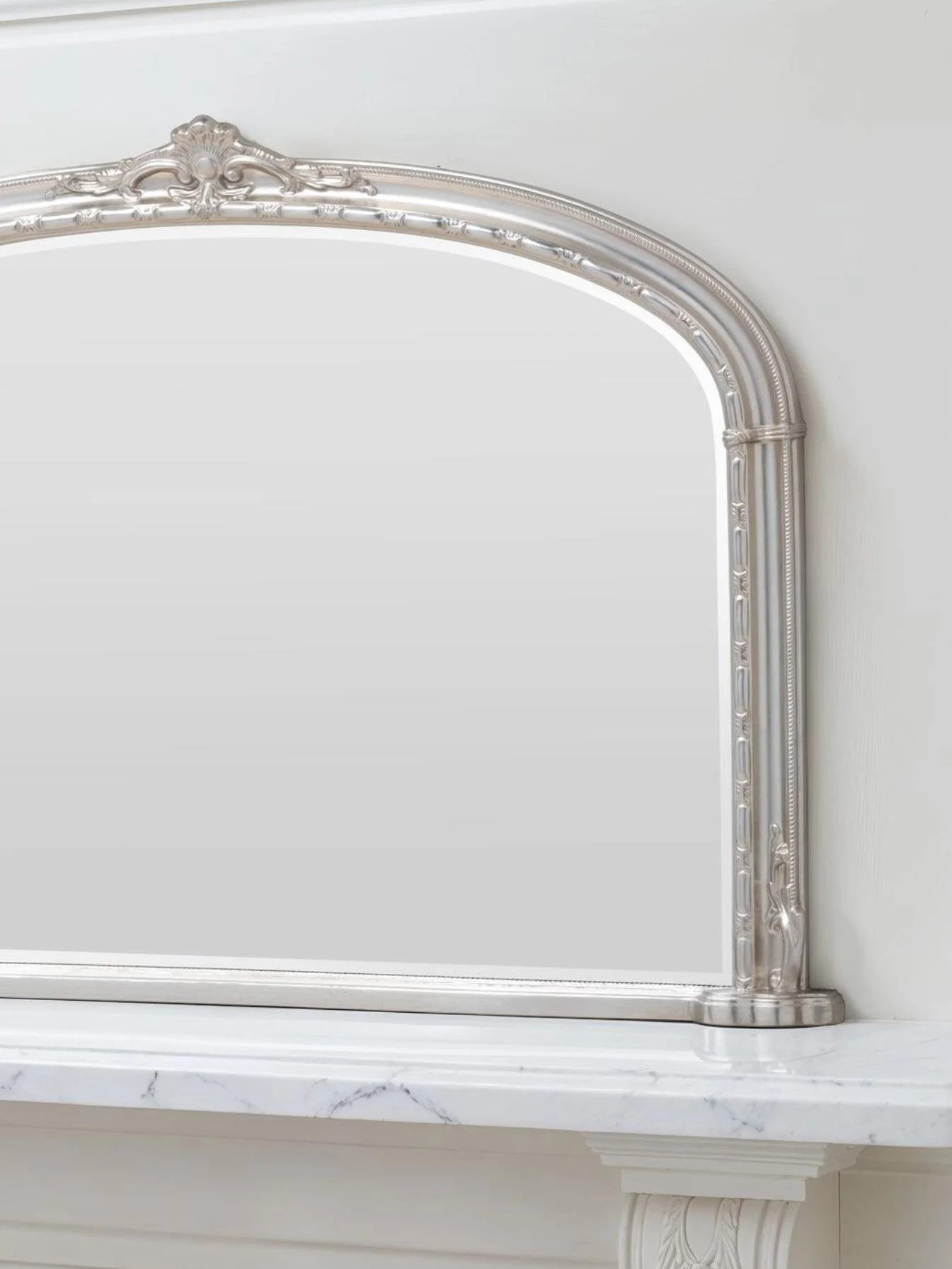 Ornate arched overmantel mirror by Yearn Mirrors London in silver