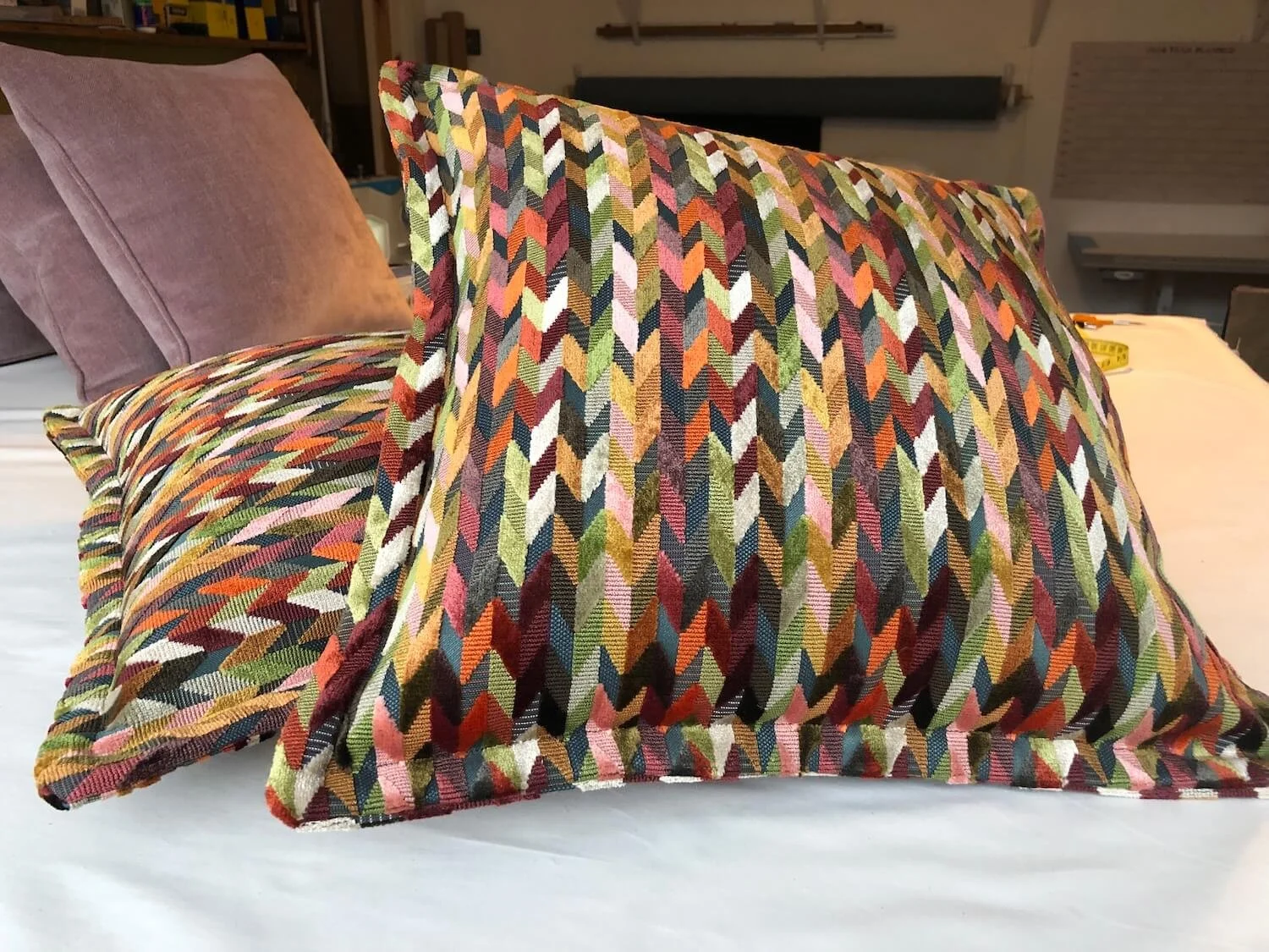 Stack of patterned scatter cushions in rich woven fabrics