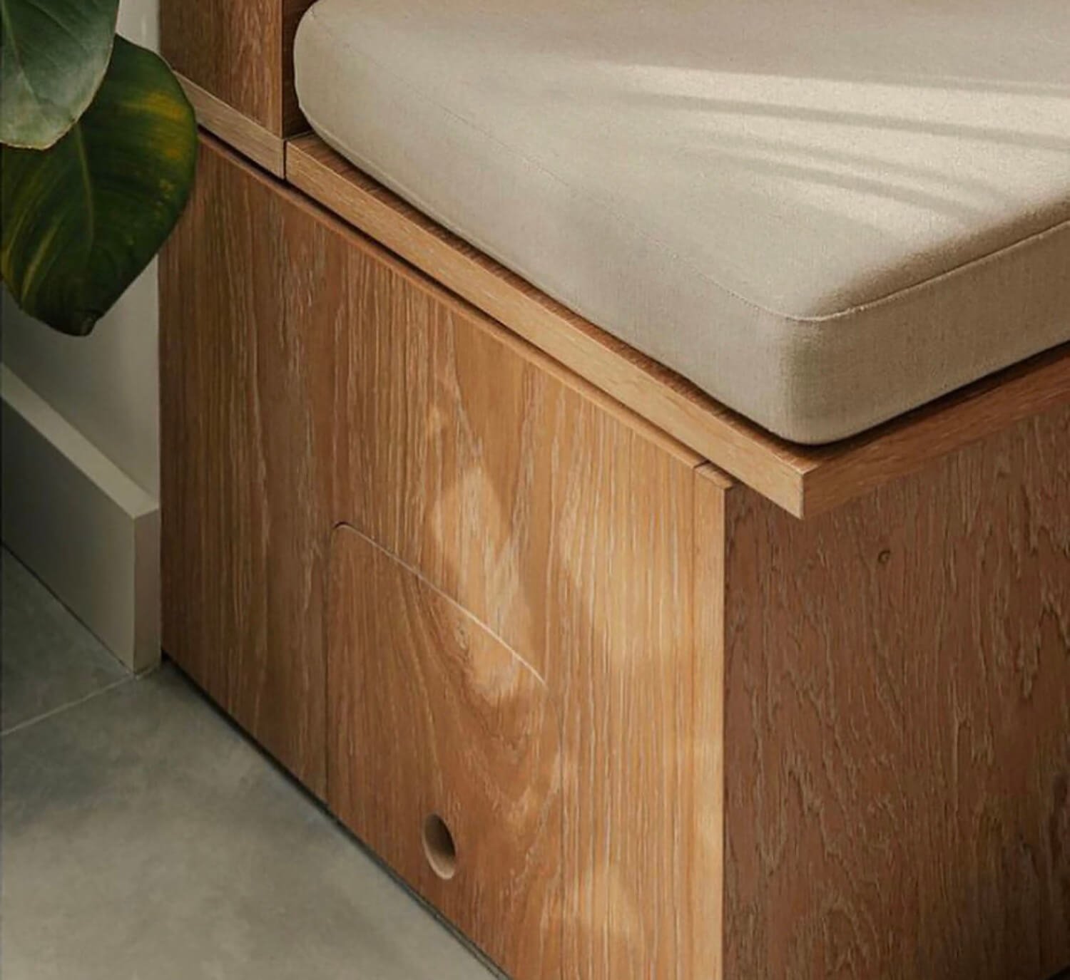 Cream upholstered bench cushion with piped edge detail