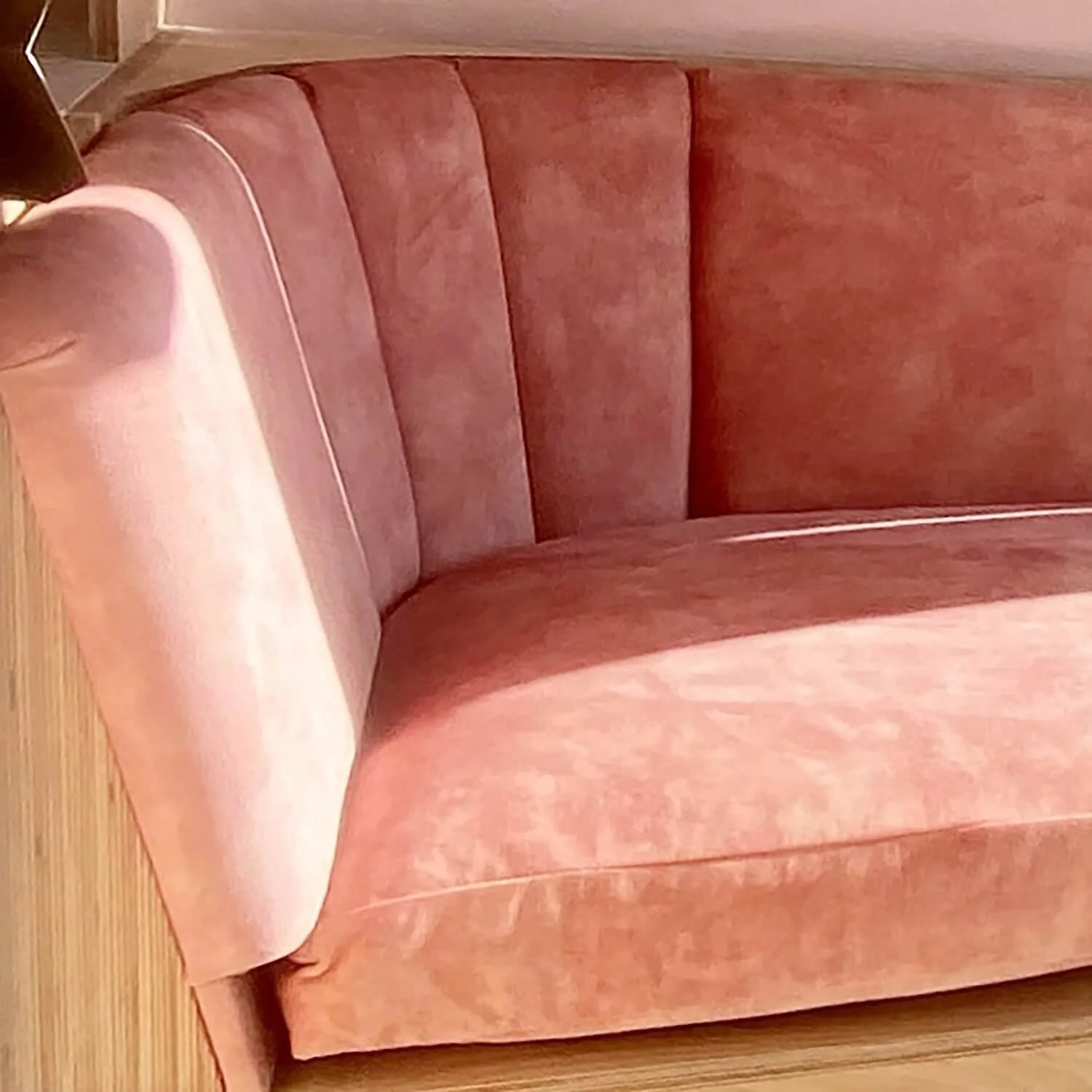 Close up of curved window seat cushion in soft pink fabric