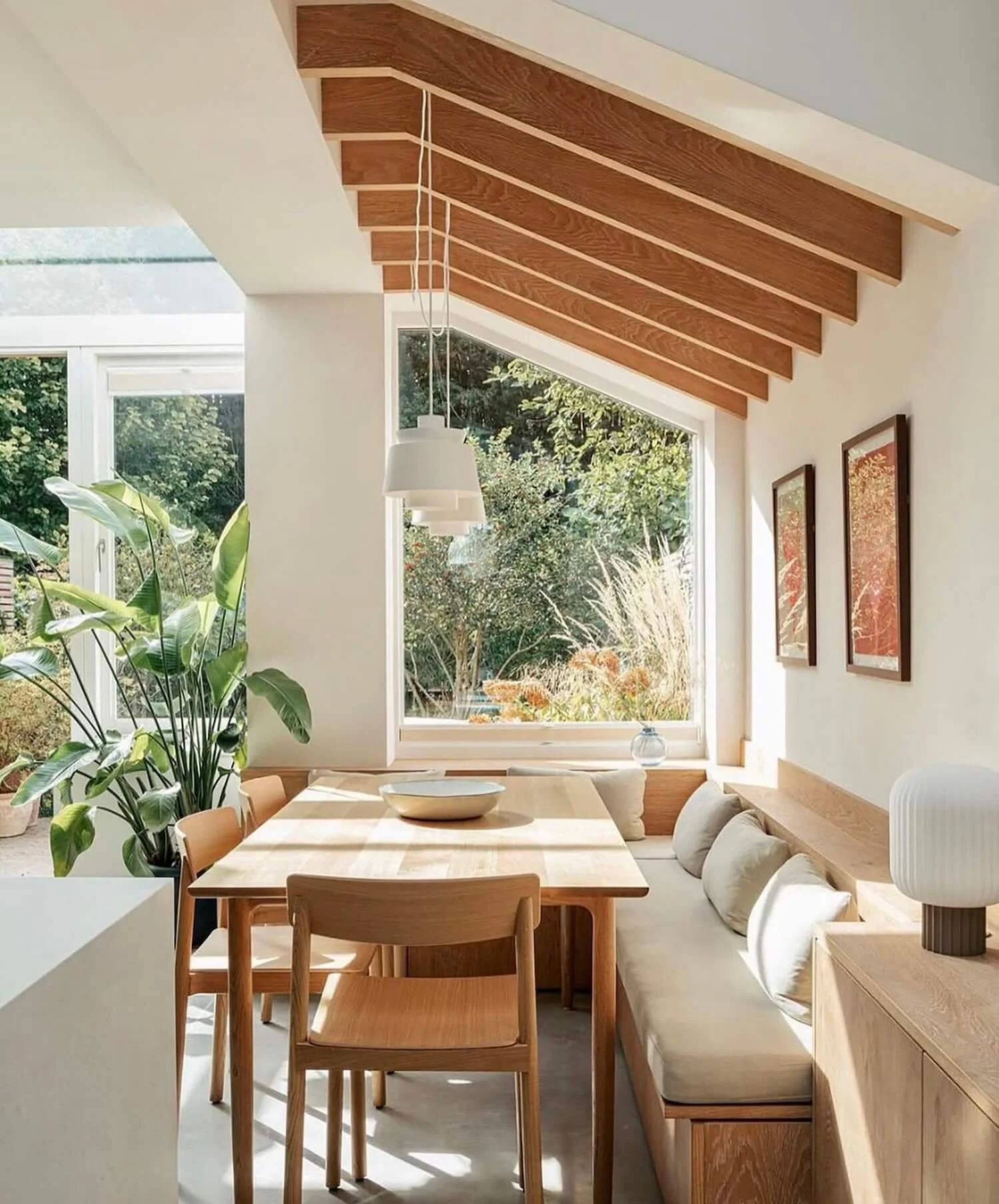 Wooden window seat with angled upholstered cushion and warm natural lighting