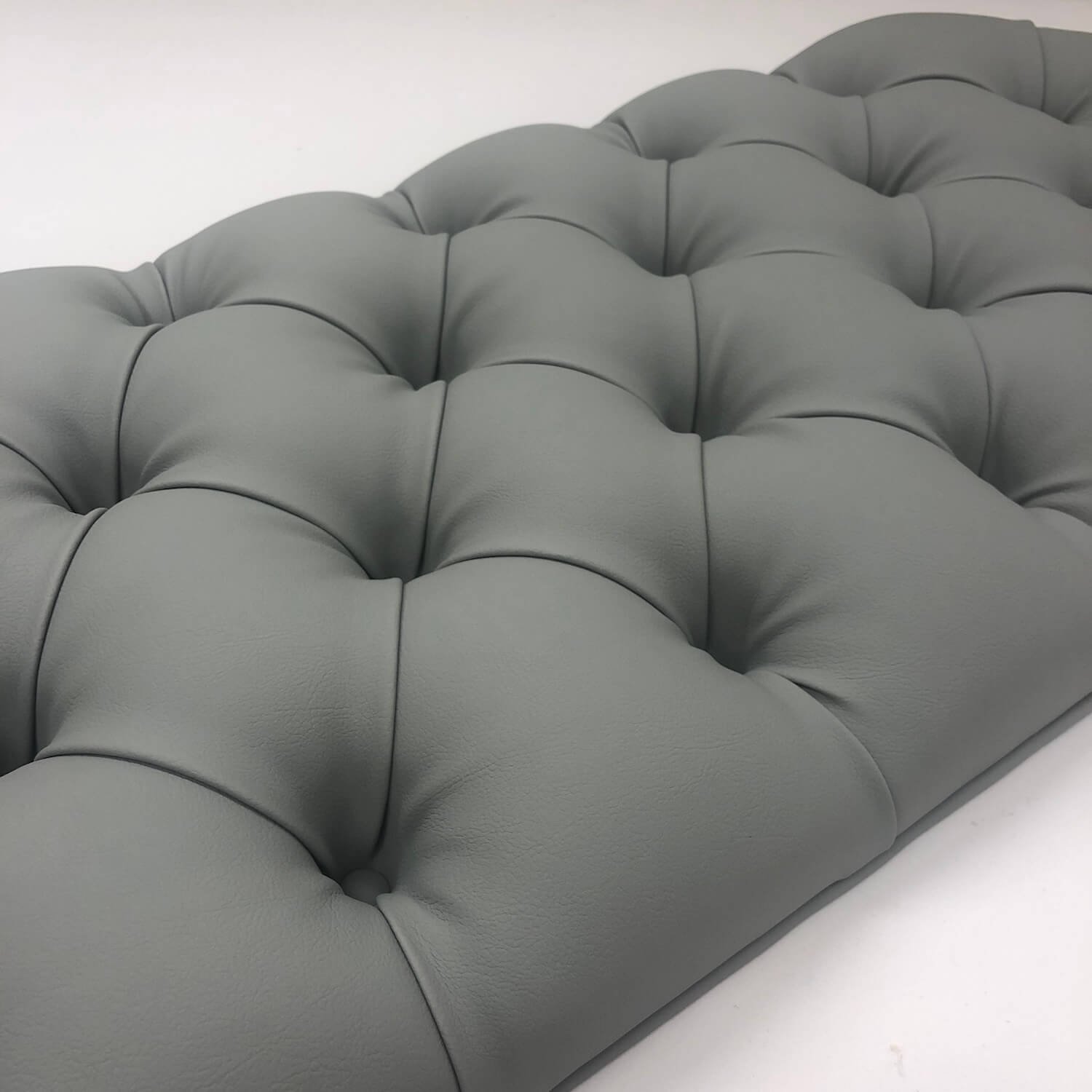 Close-up of deep buttoned bench cushion in grey fabric